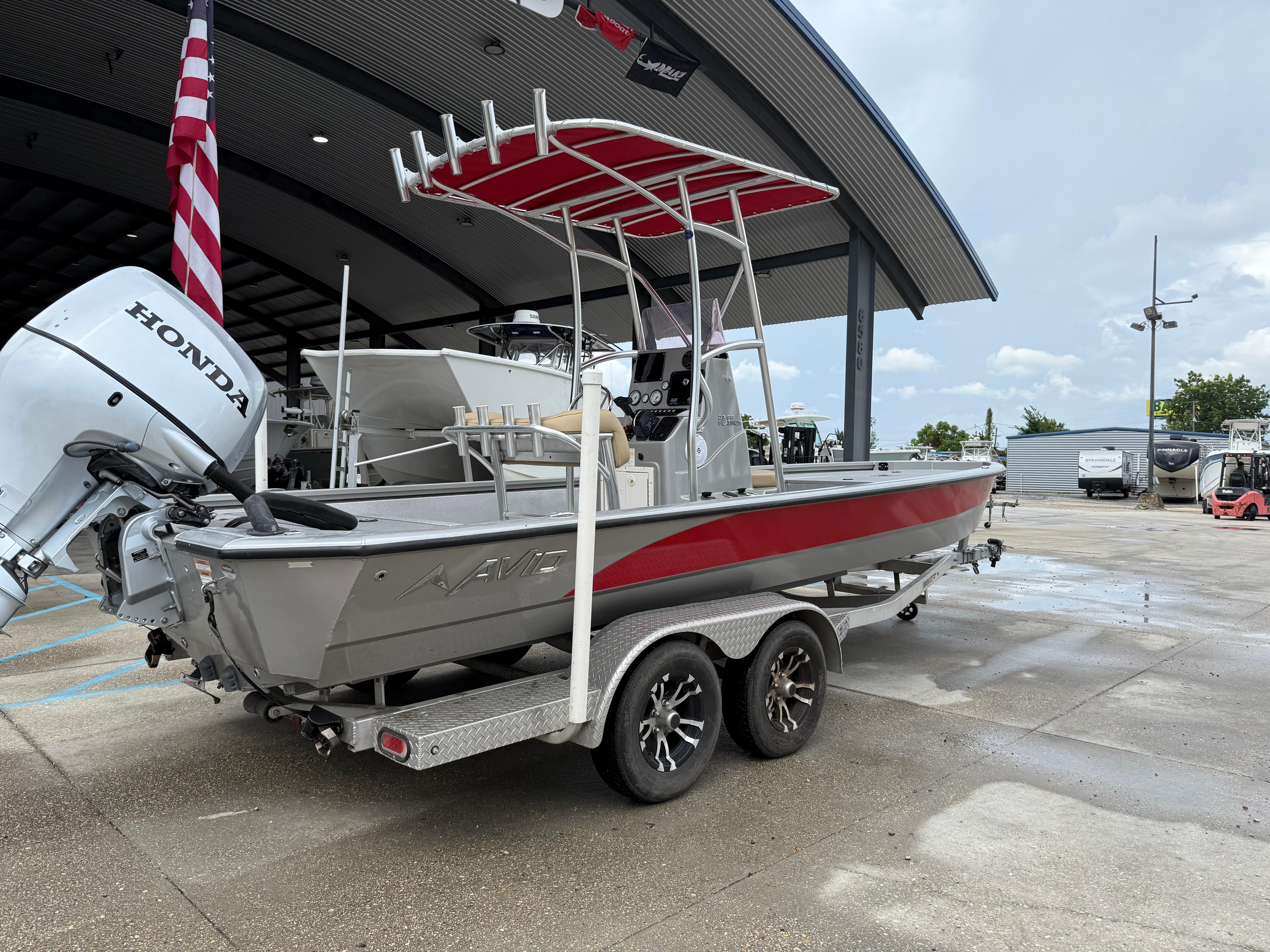2020 Avid 23 FS Platinum boat with Honda engine on trailer, parked outdoors.