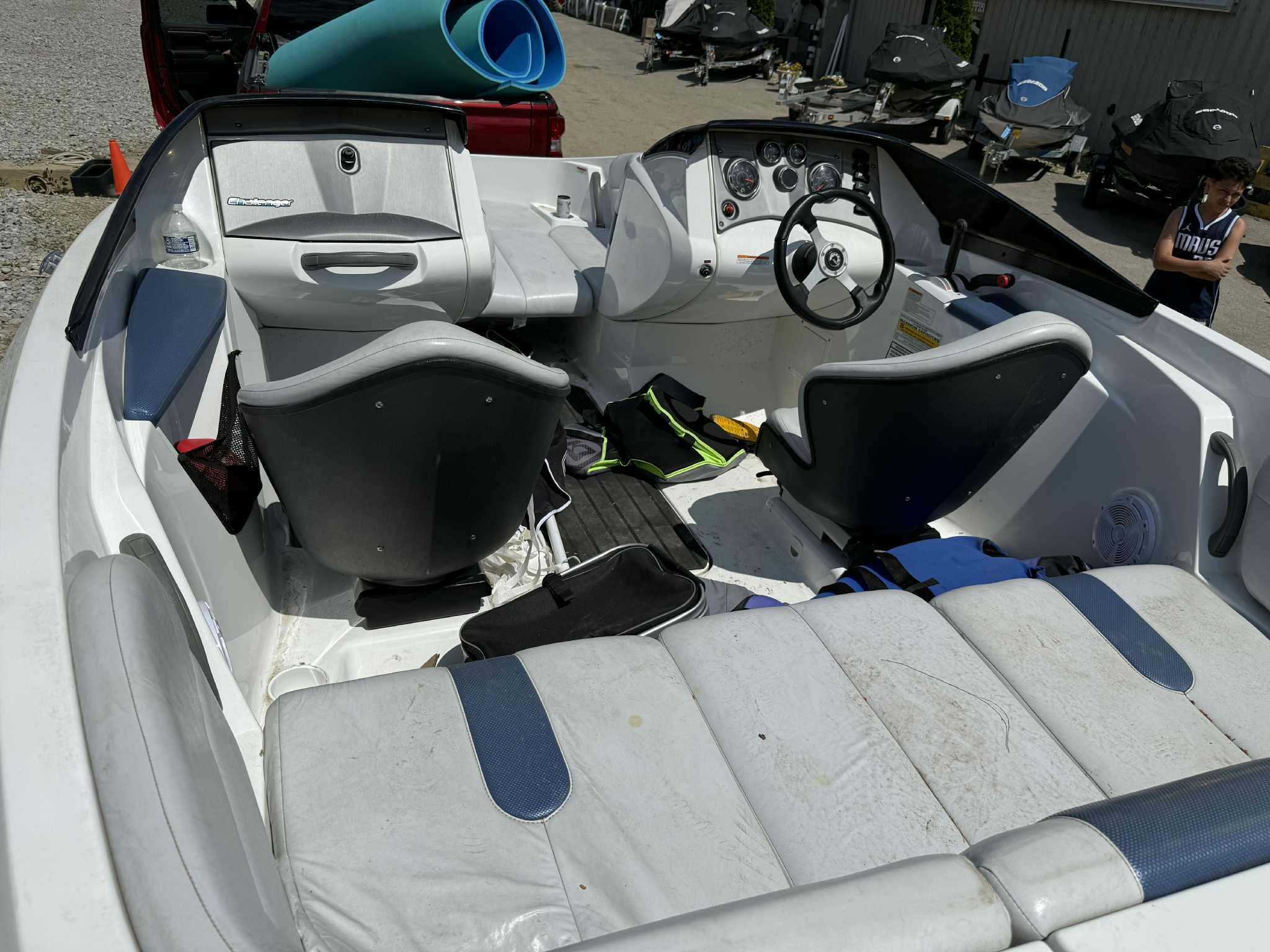 2006 Sea-Doo 180 Challenger interior with seating and dashboard, parked outdoors.