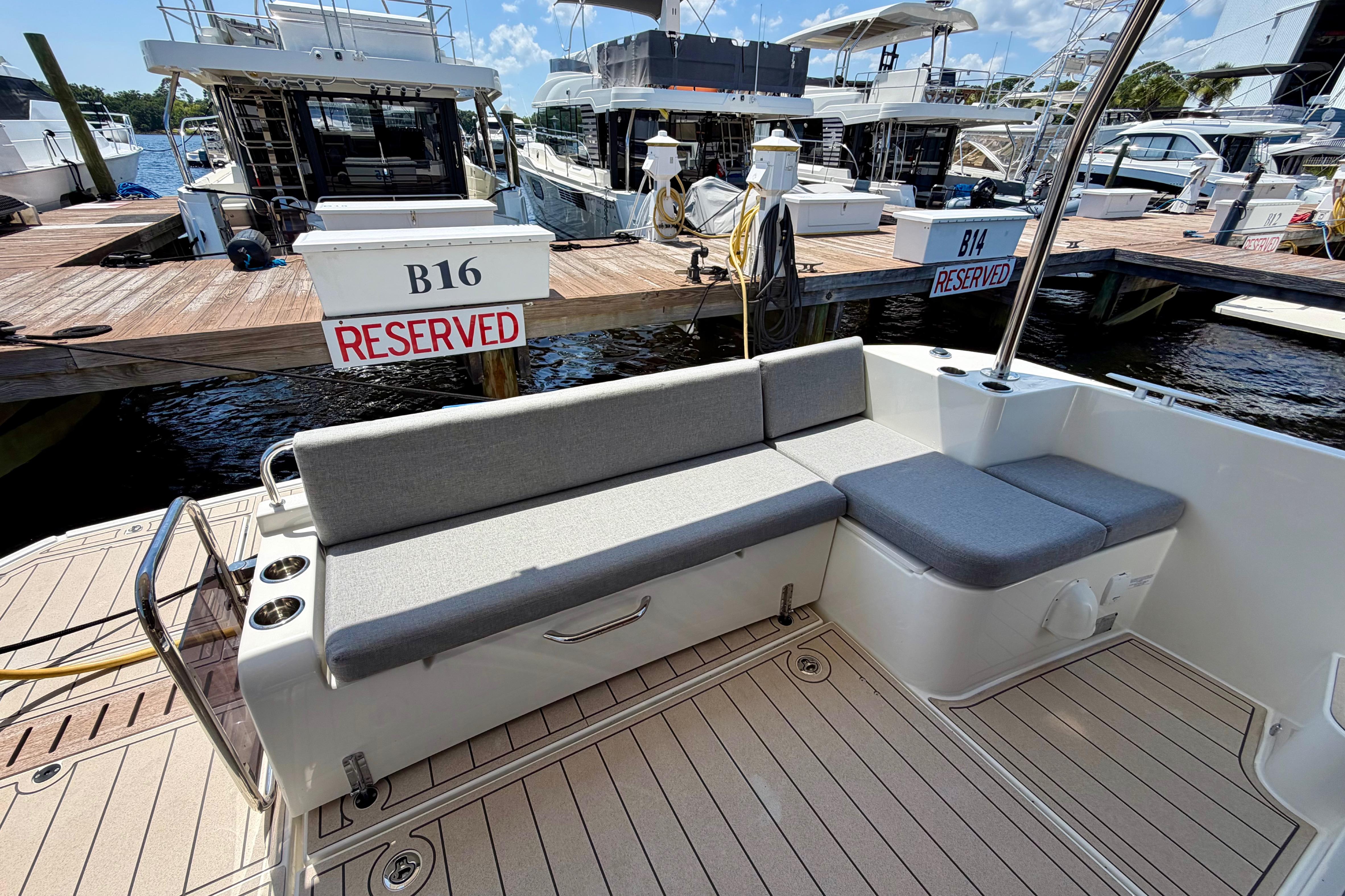 2025 Beneteau Swift Trawler 41 Fly, docked with reserved seating area, marina view.