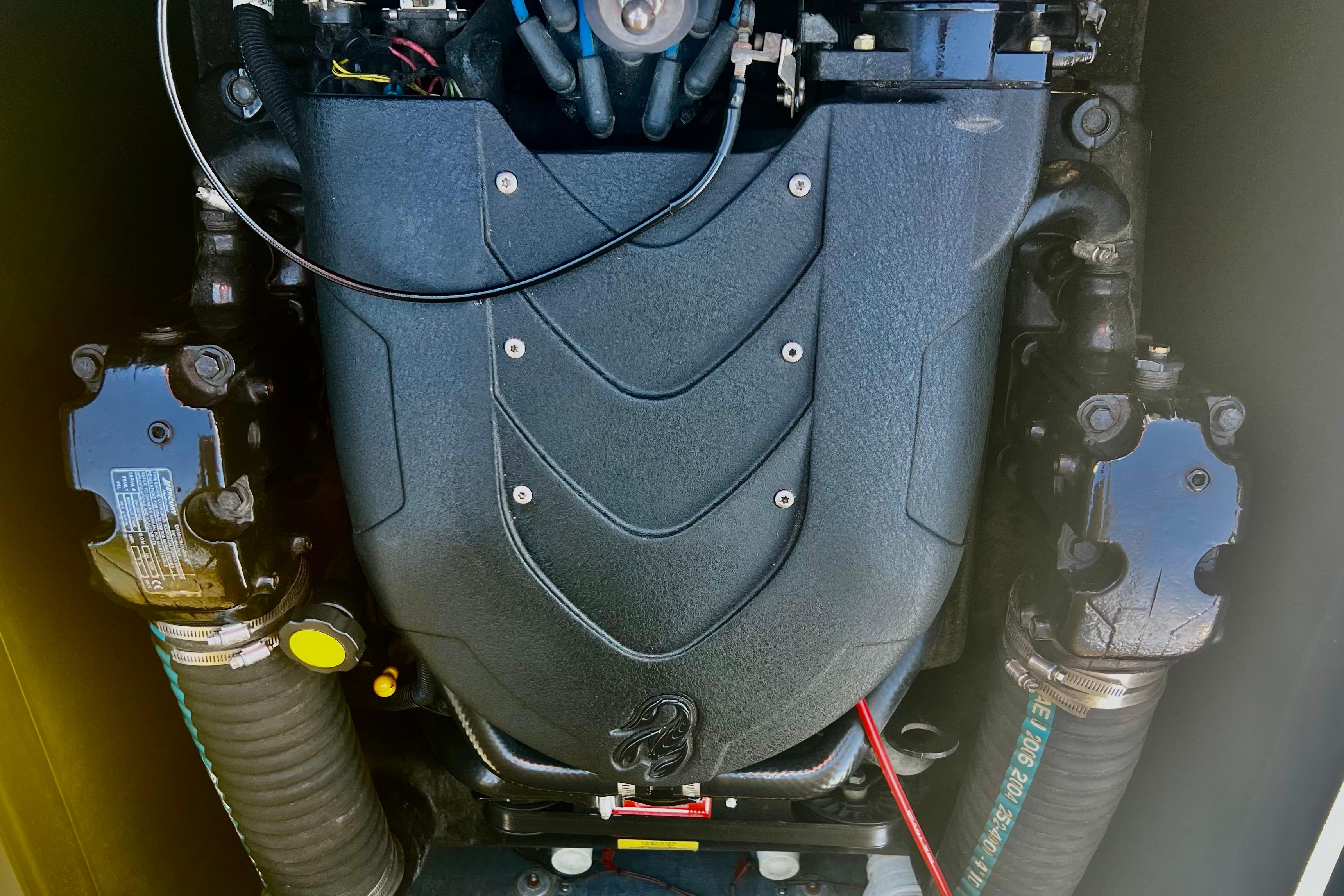 Engine of a 2006 Sanger V230 boat, showcasing detailed components and design.