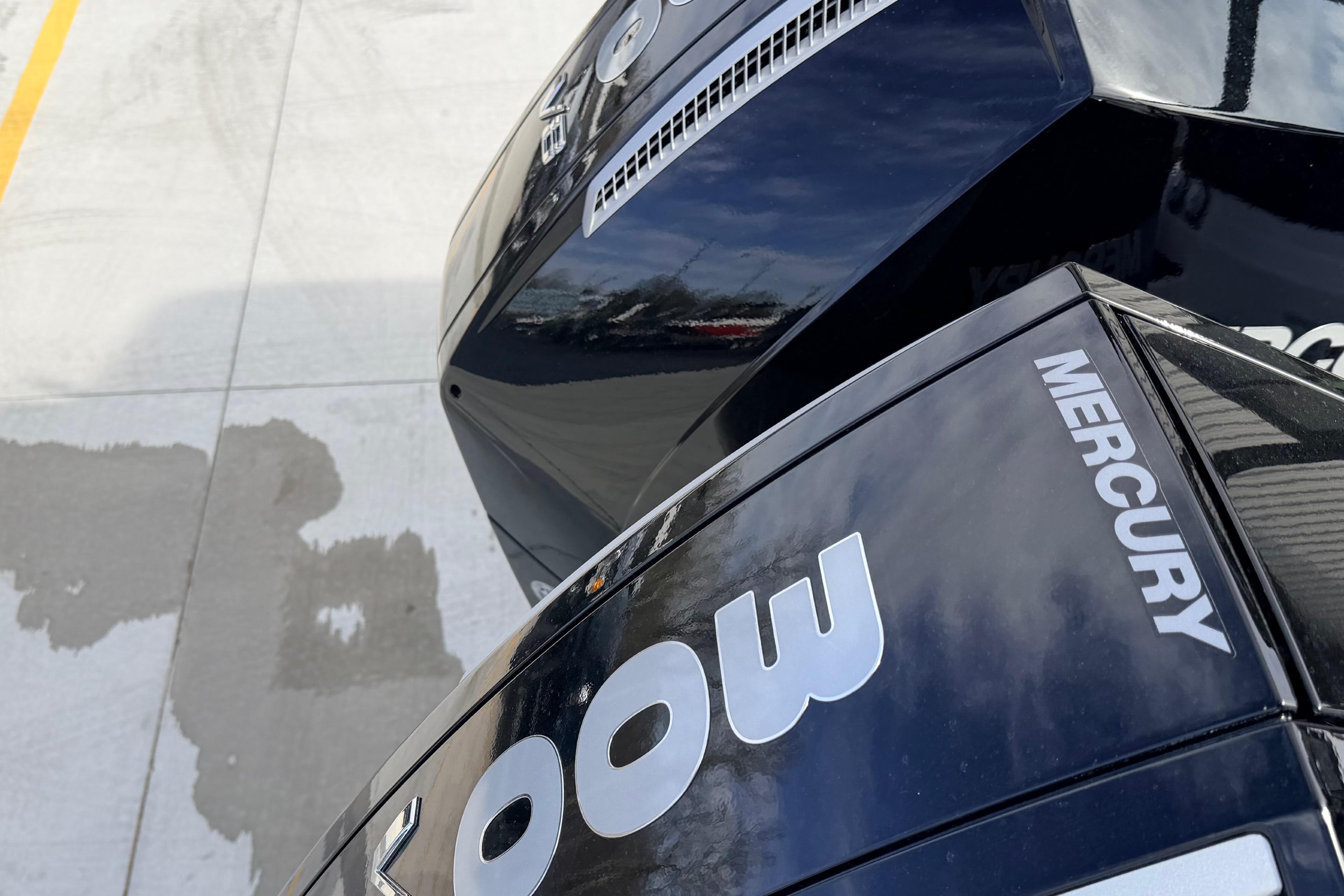 Close-up of 2026 Navan S30 Mercury engine, reflecting sky and surroundings.