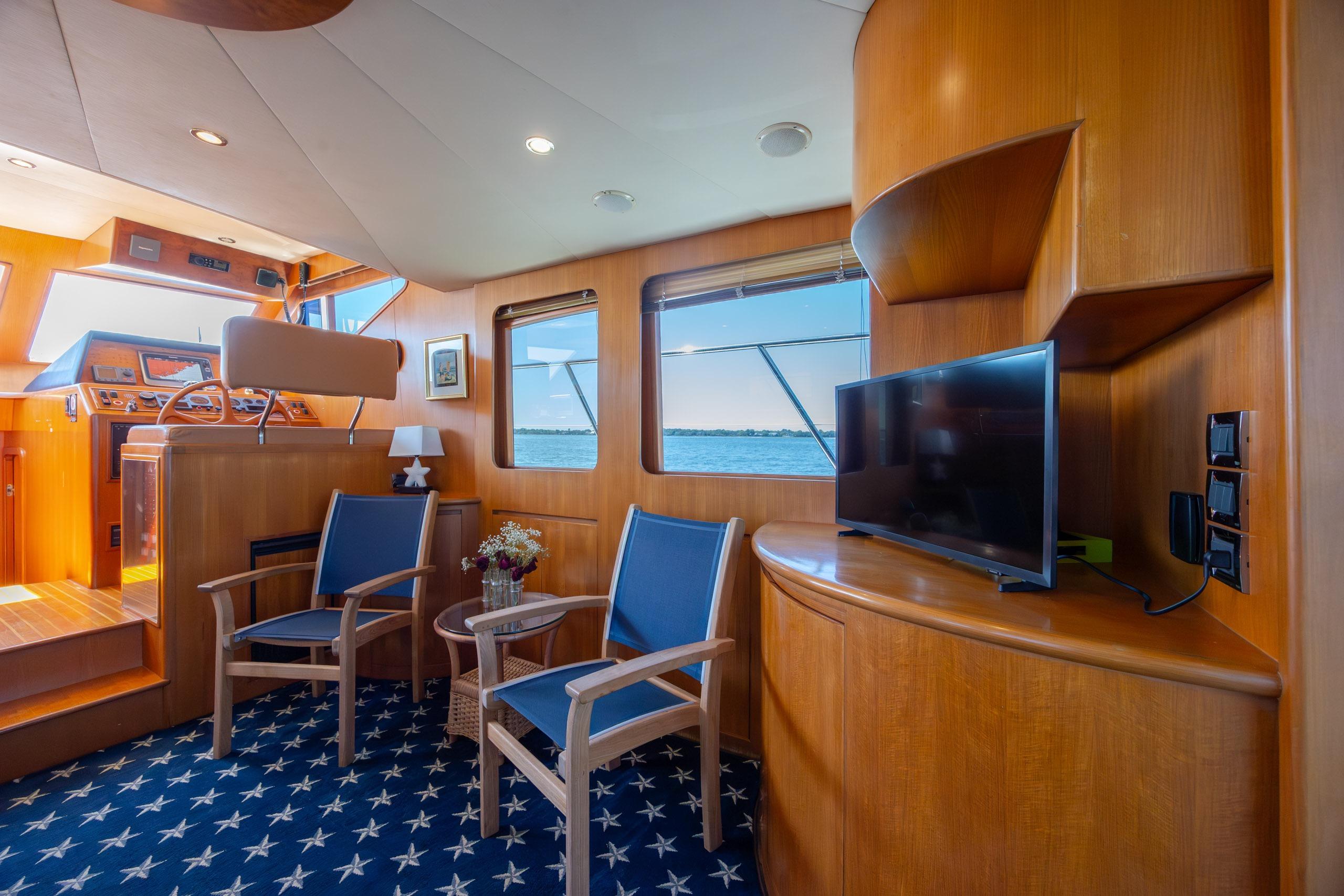 Luxurious interior of 2005 Ocean Alexander 52 Sedan yacht with elegant wood finish and seating.