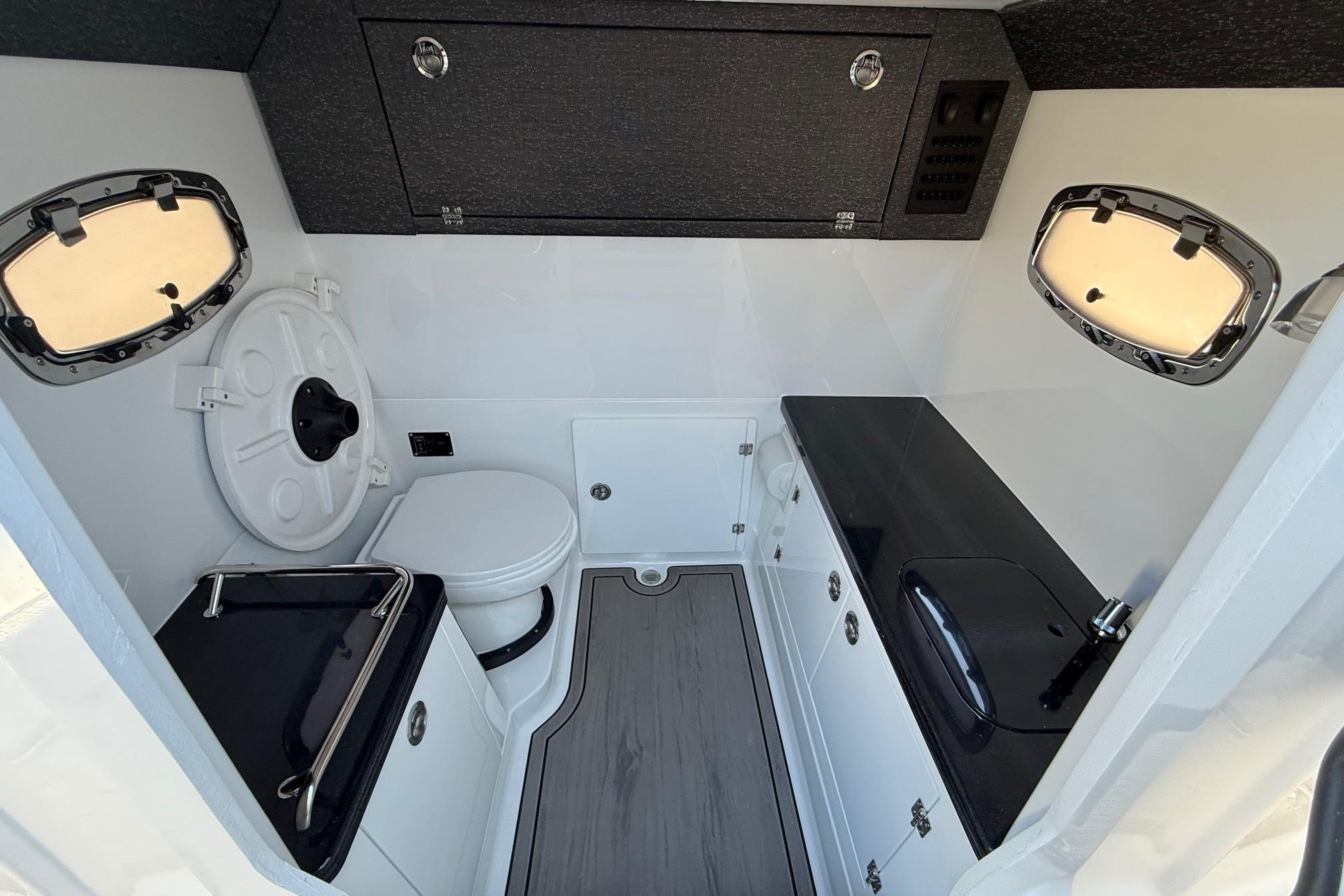 Interior of 2026 Monterey Elite 30 OB with toilet and sink.