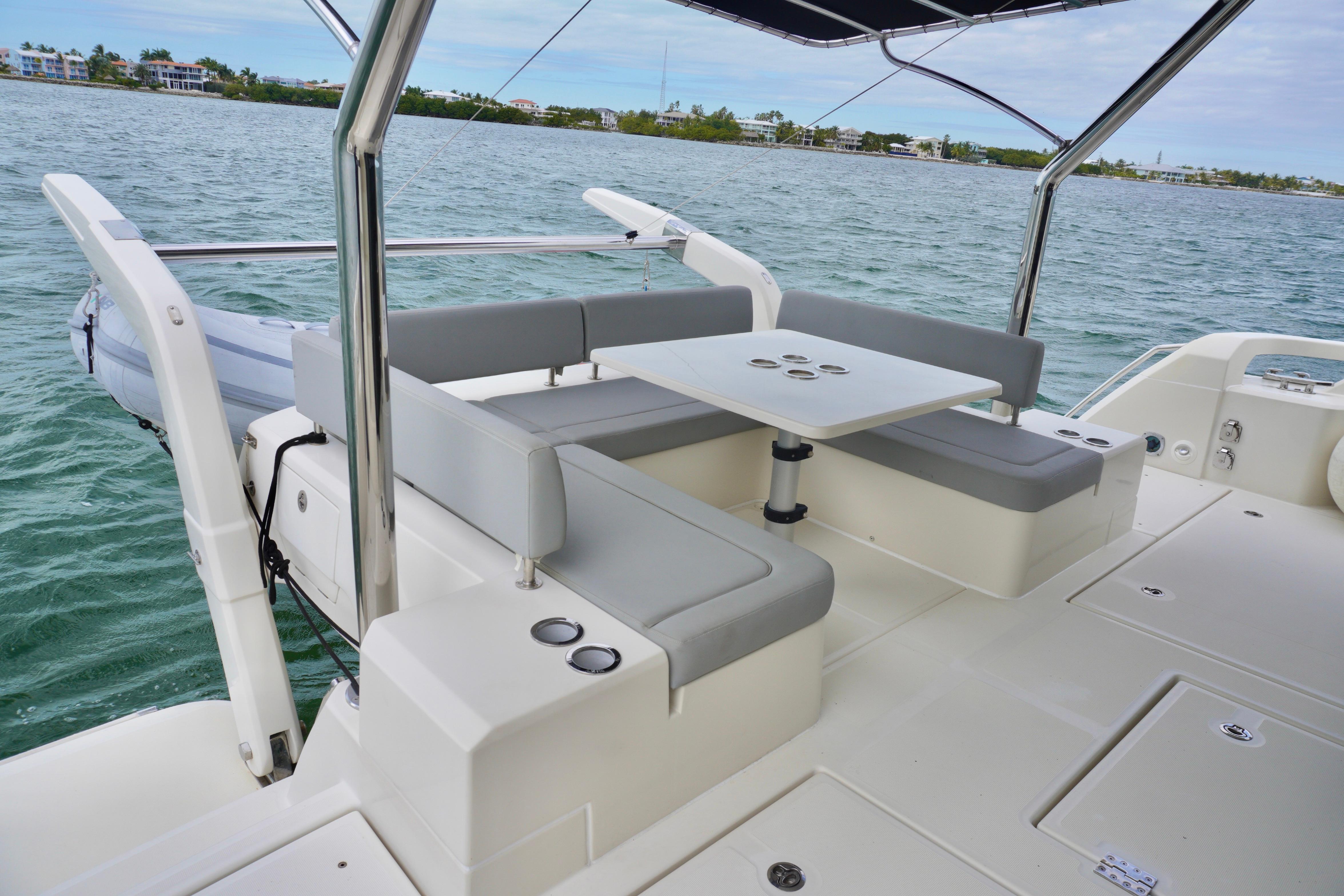 2017 Aquila 44 Yacht with outdoor seating and table on calm waters.