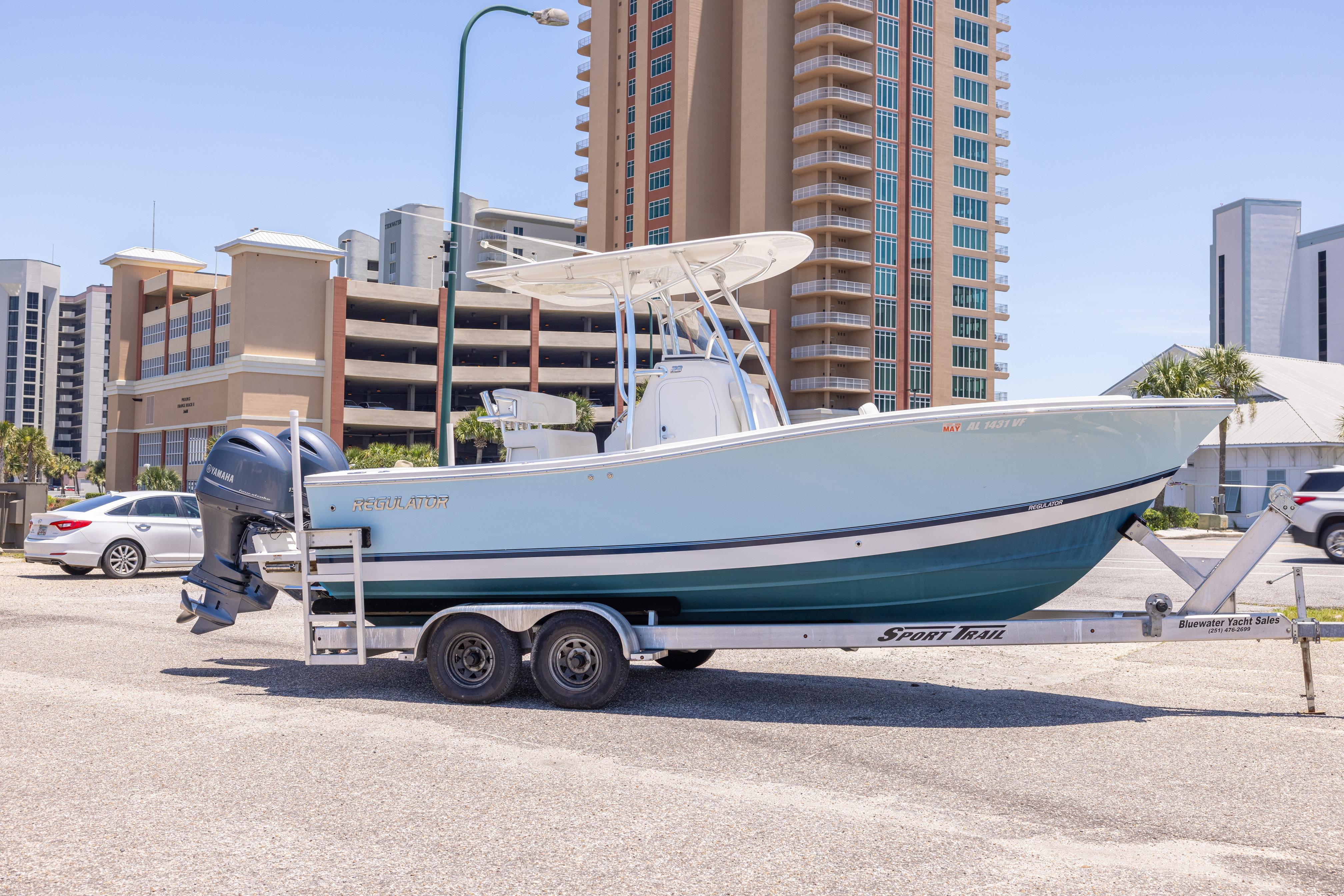 2019 Regulator 23 Center Console boat on trailer in urban setting.