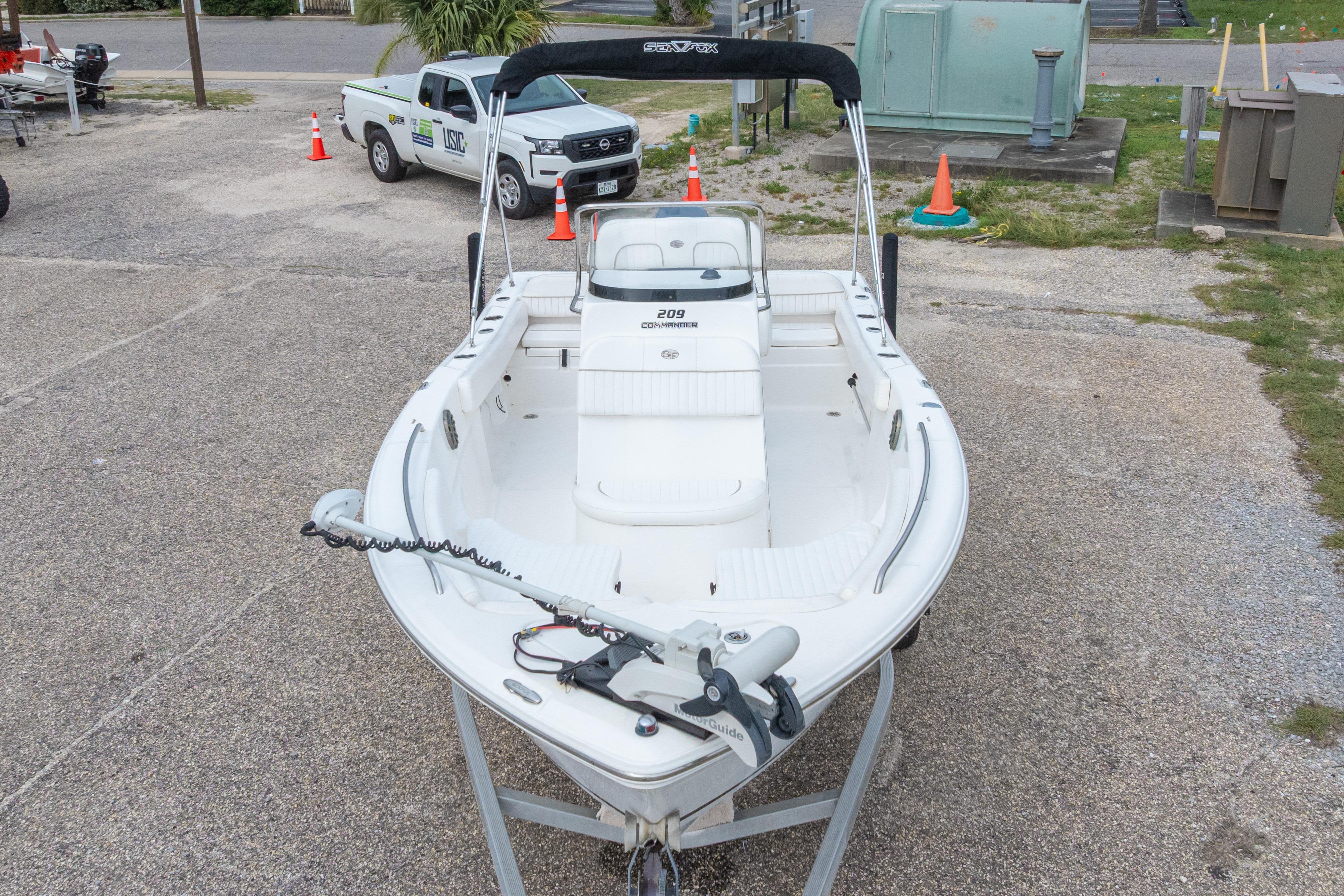 2014 Sea Fox 209 Commander boat on trailer, parked outdoors.