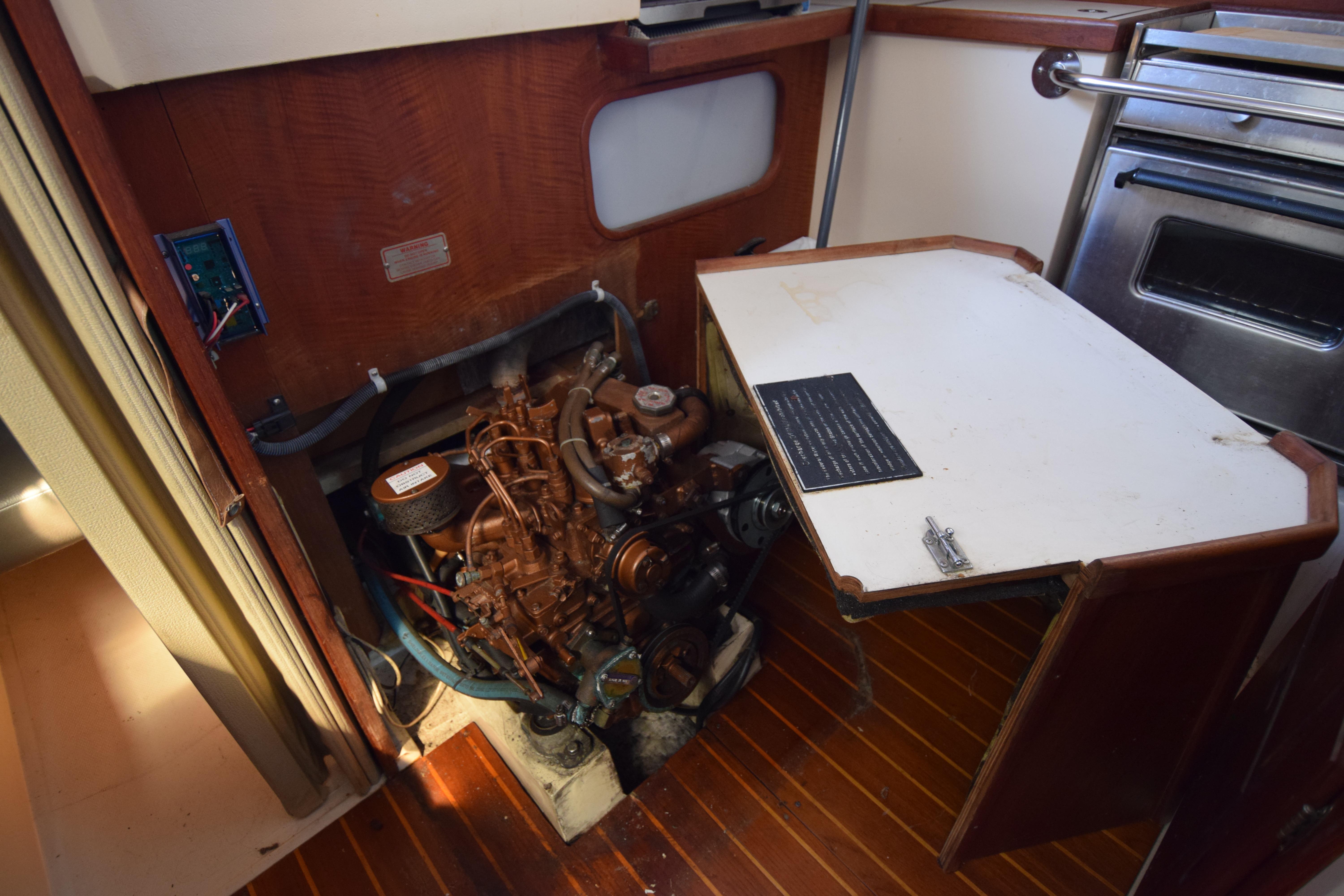 Engine compartment of a 1989 Catalina 36 sailboat, featuring a compact marine engine.