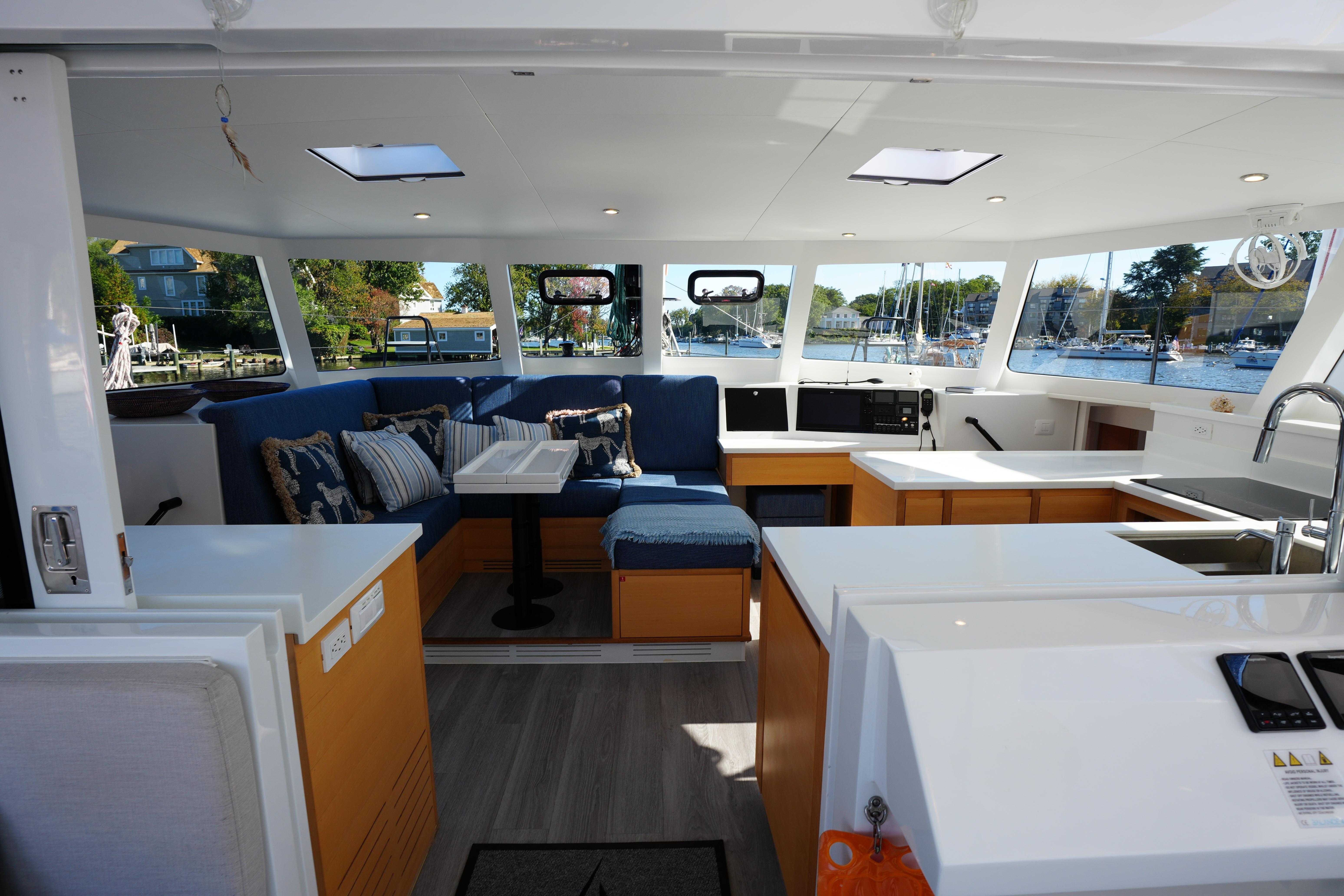 Luxurious interior of 2024 Balance 442 yacht with modern seating and kitchen area.
