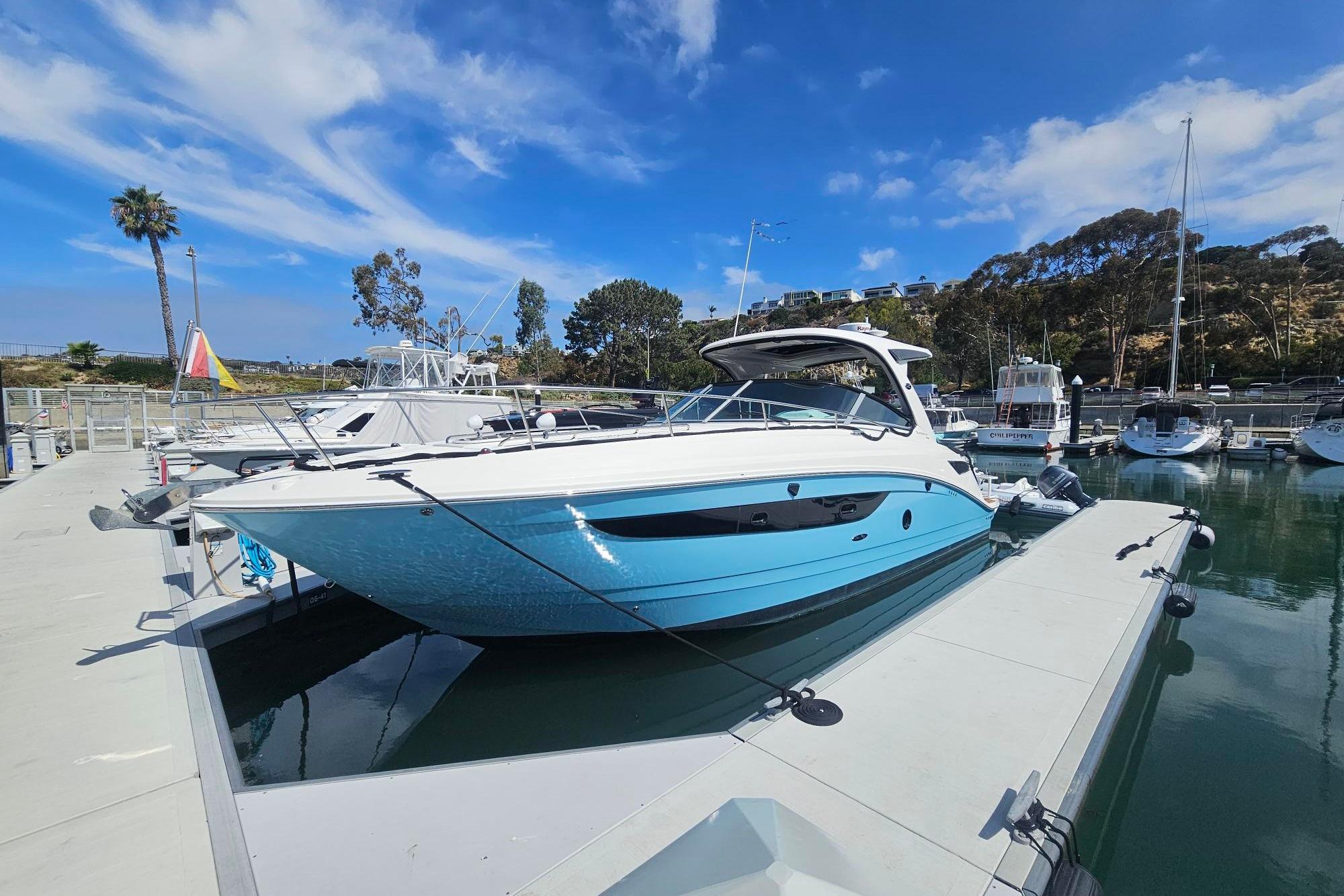 2016 Sea Ray Sundancer 350 docked at marina under blue sky.