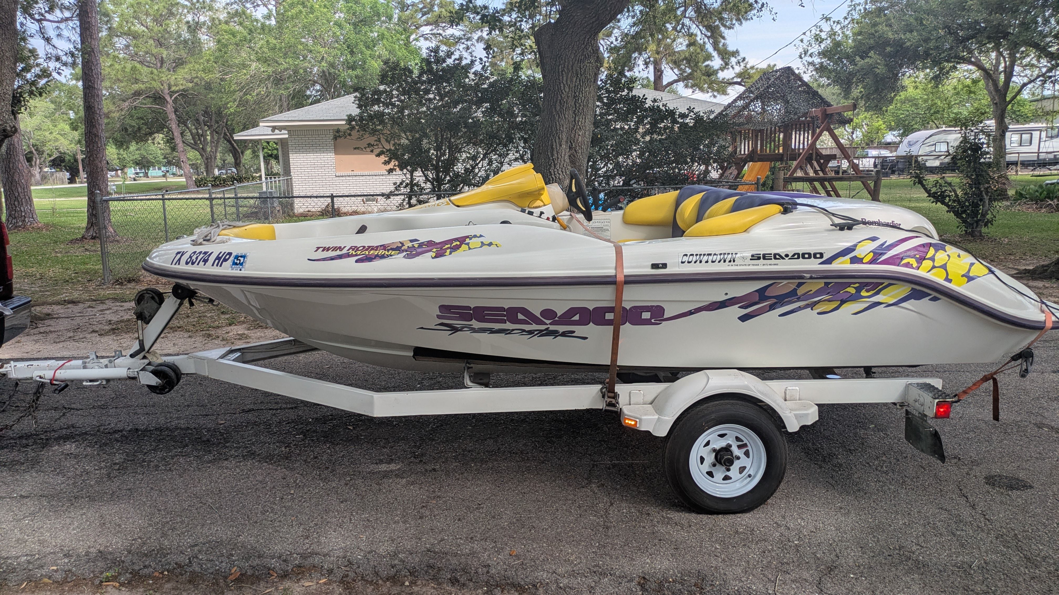 A 1995 Bombardier SeaDoo SPEEDSTER on a trailer, parked on a residential street.