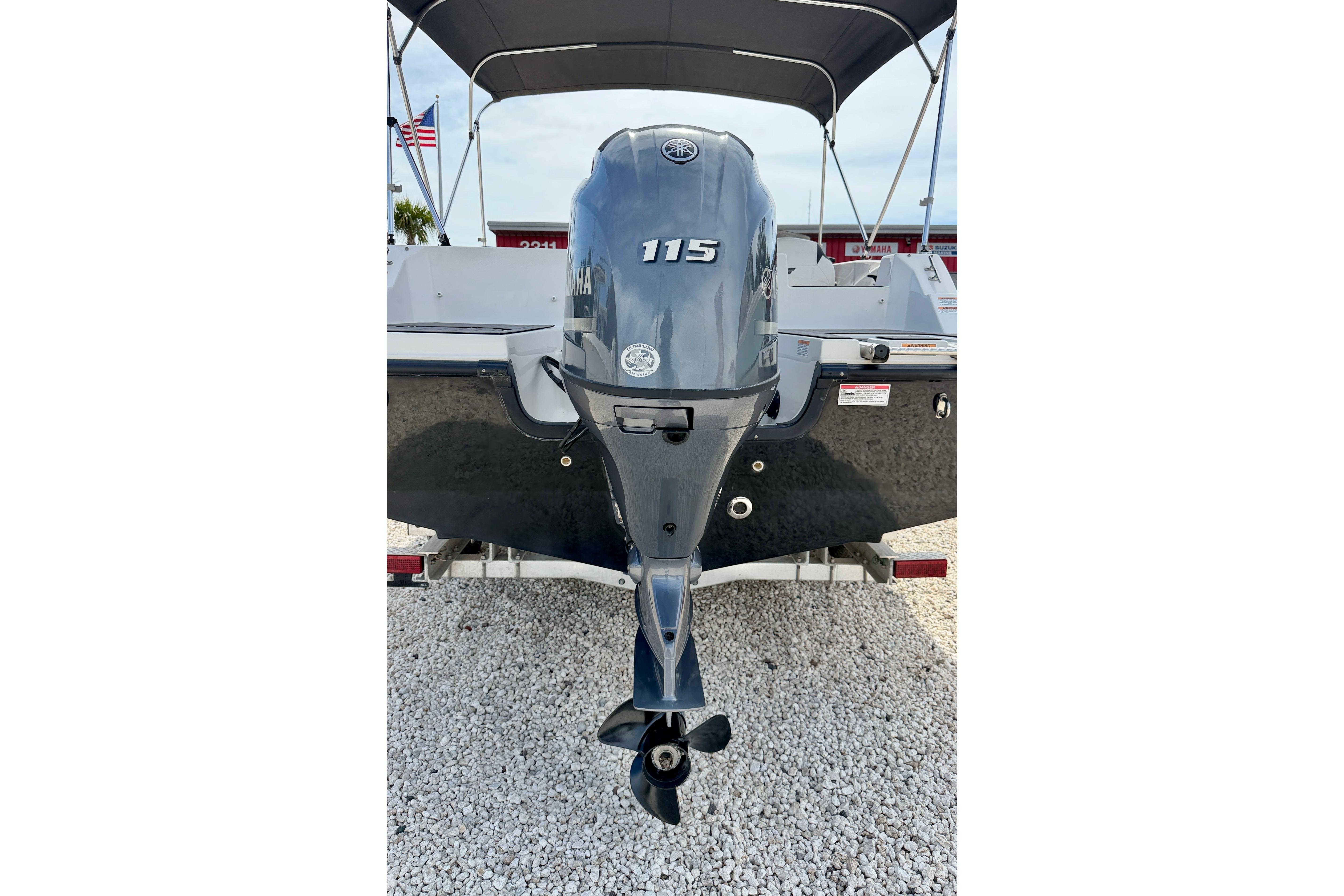 2021 Starcraft SVX 191 OB boat with Yamaha 115 outboard motor, parked on gravel.