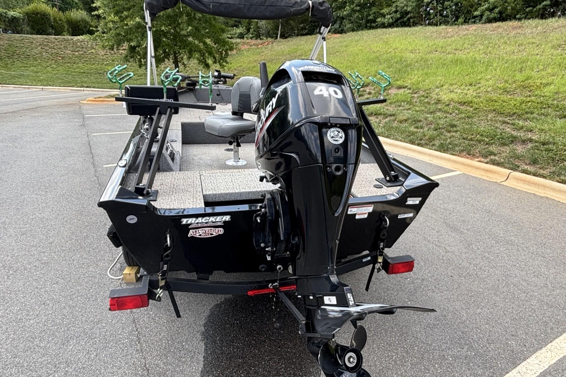 2022 Tracker Super Guide V-16 T boat with Mercury 40 HP engine in parking lot.