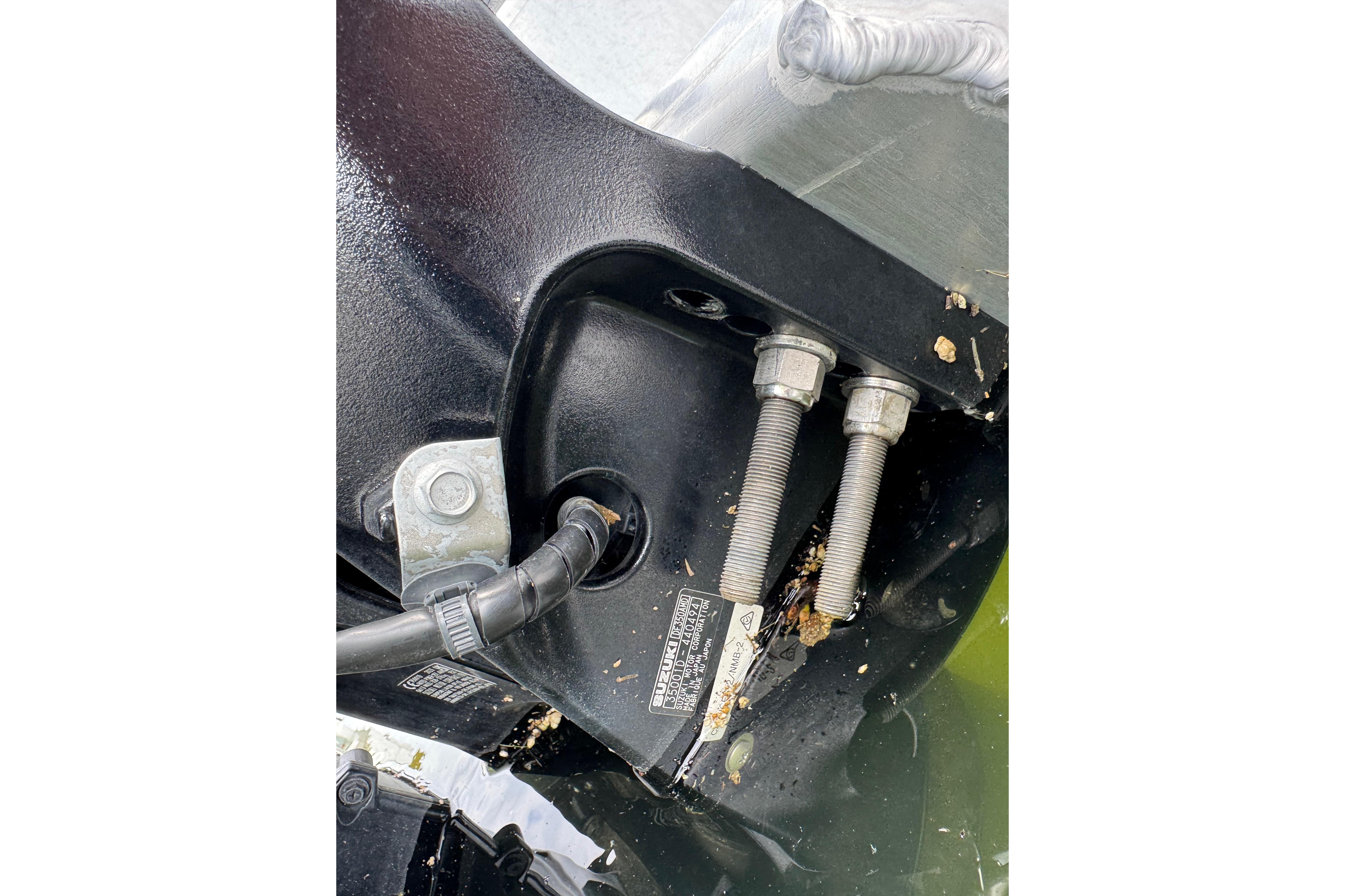 Close-up of 2023 Starcraft MX 25 DL DH boat engine bolts and wiring.