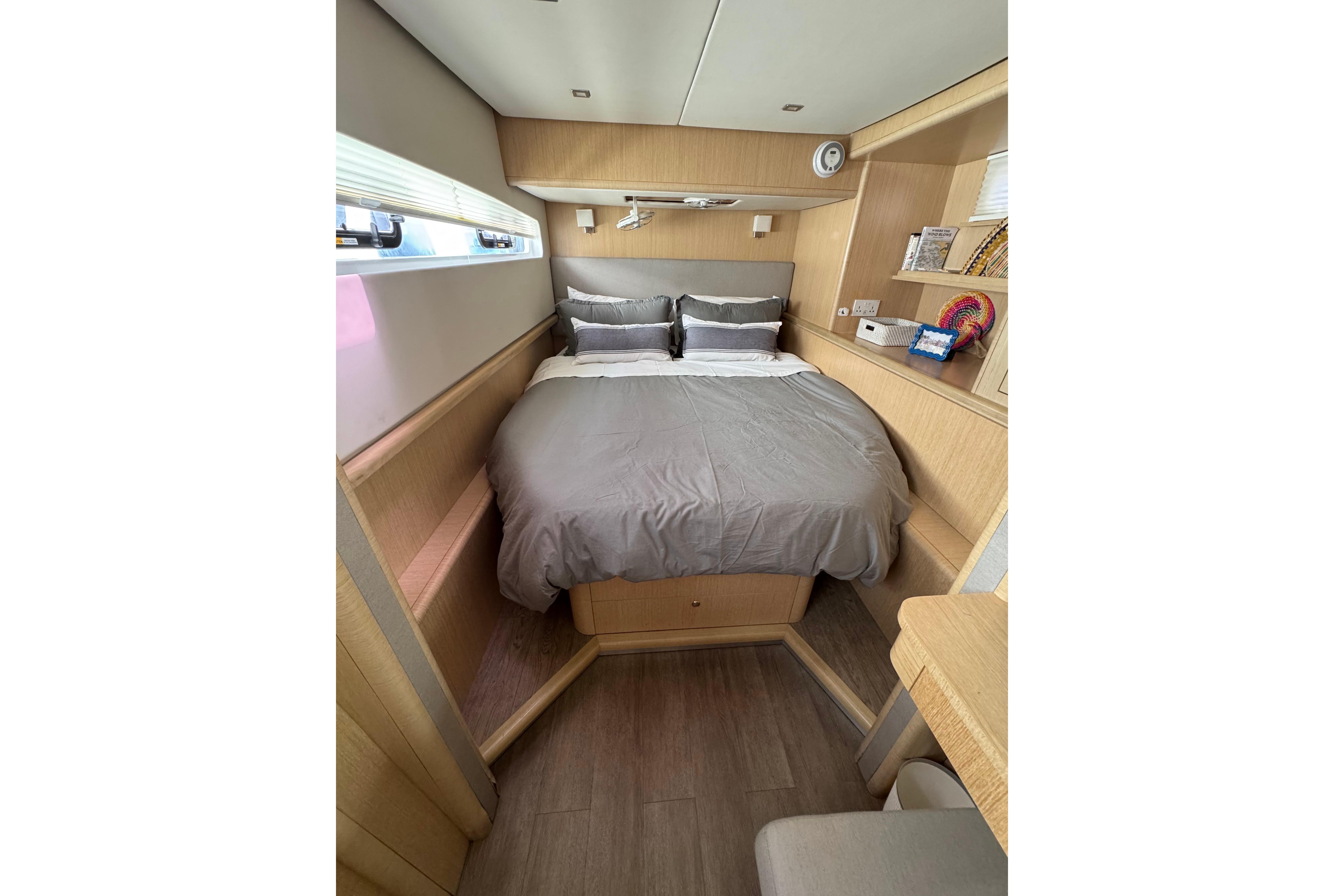 Luxurious cabin interior of 2023 Seawind 1600 yacht with cozy bed and modern decor.