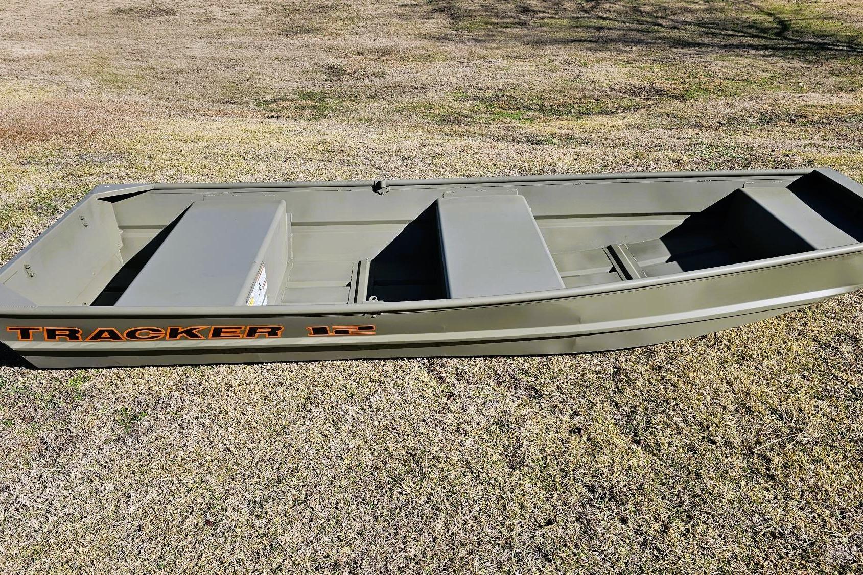 2026 Tracker Grizzly 12 Jon boat on grass, showcasing its sturdy design and spacious interior.