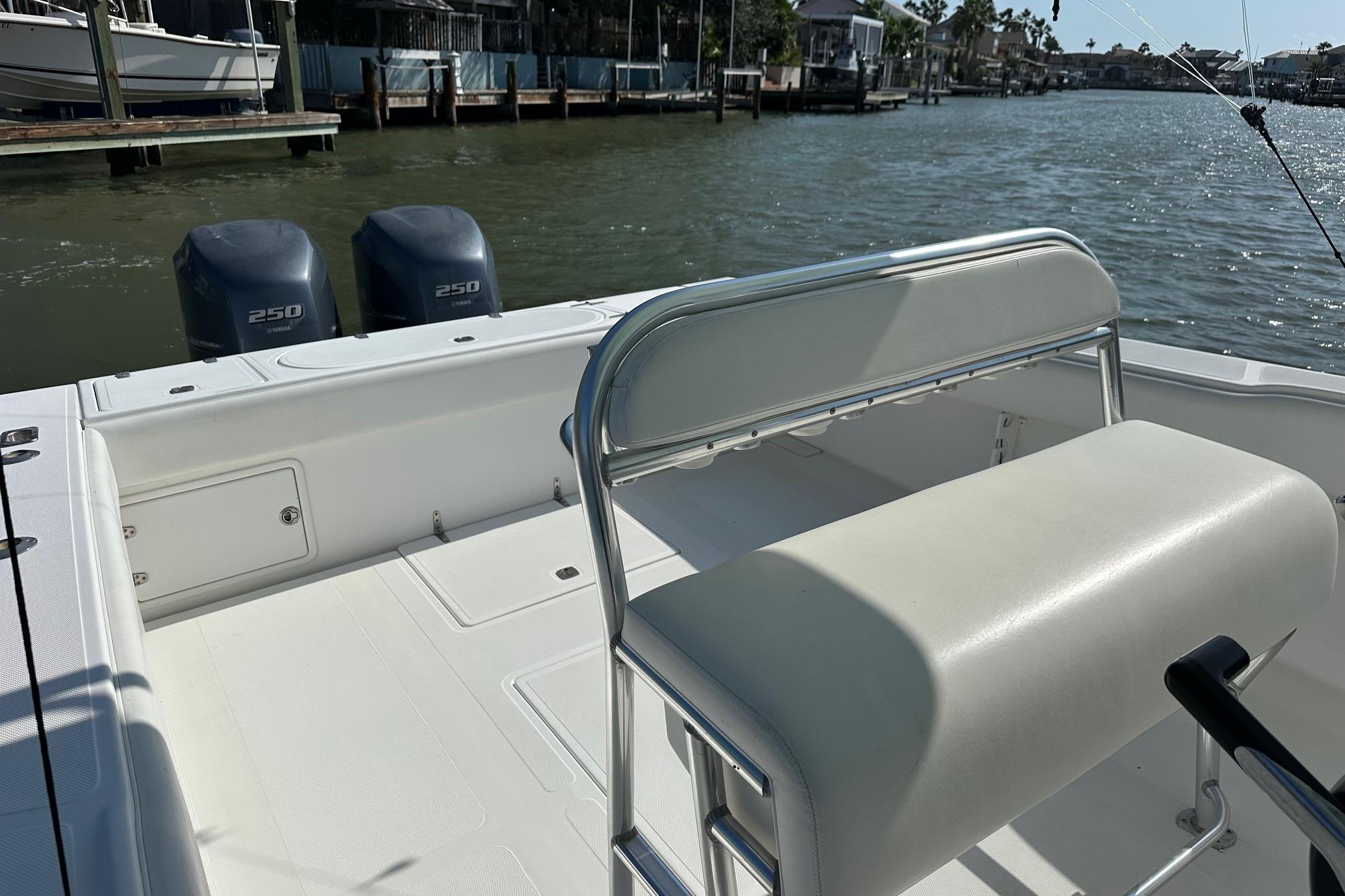 2003 Venture 34 Center Console boat with dual 250 horsepower engines on a calm waterway.
