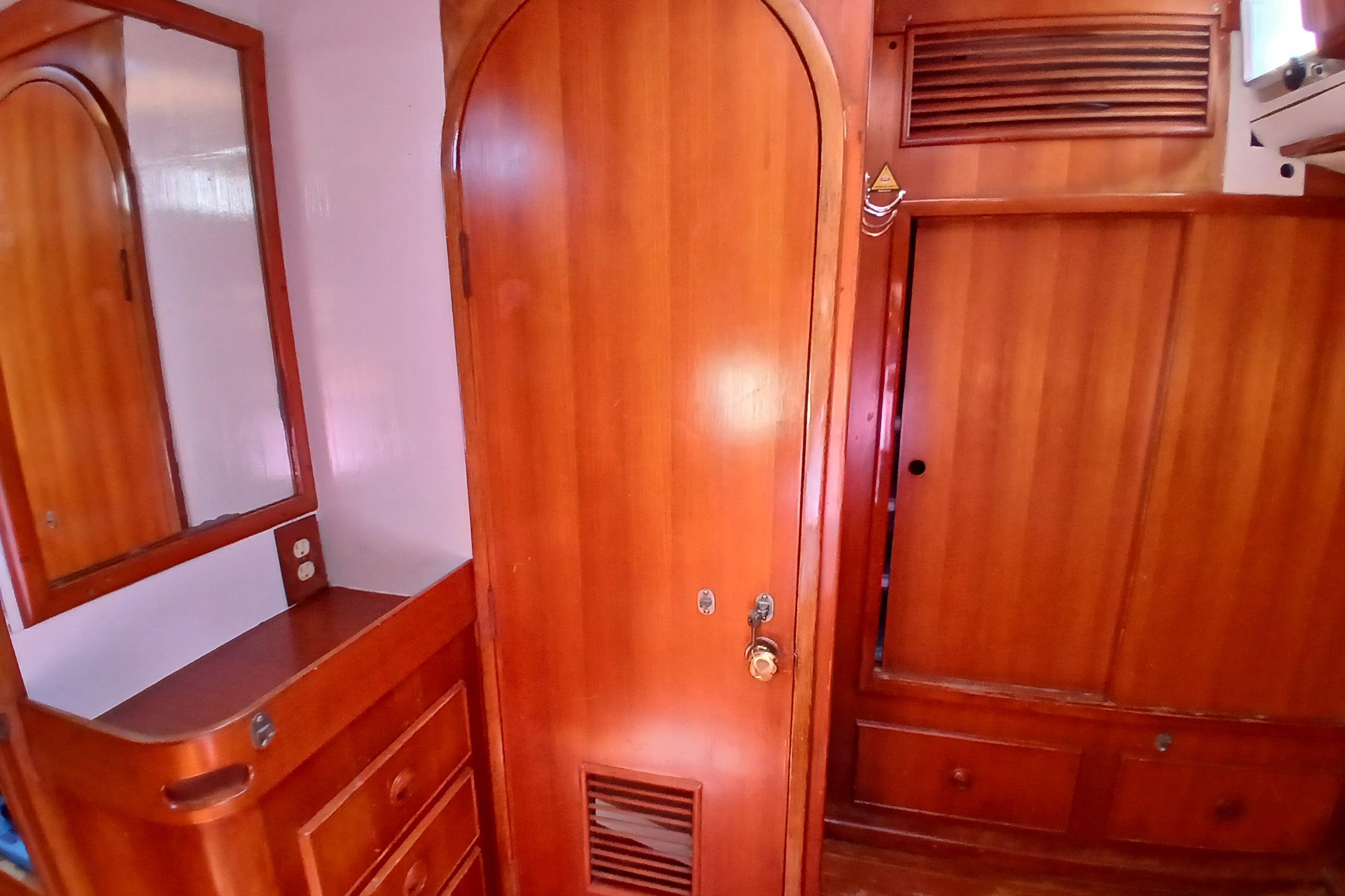 Wooden interior of 1981 SKYE 51 yacht with cabinets and mirror.