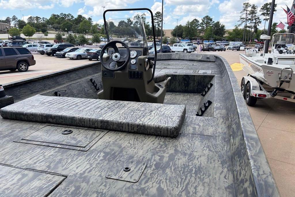 2026 Tracker Grizzly 2072 CC boat with camouflage design, parked in a lot.