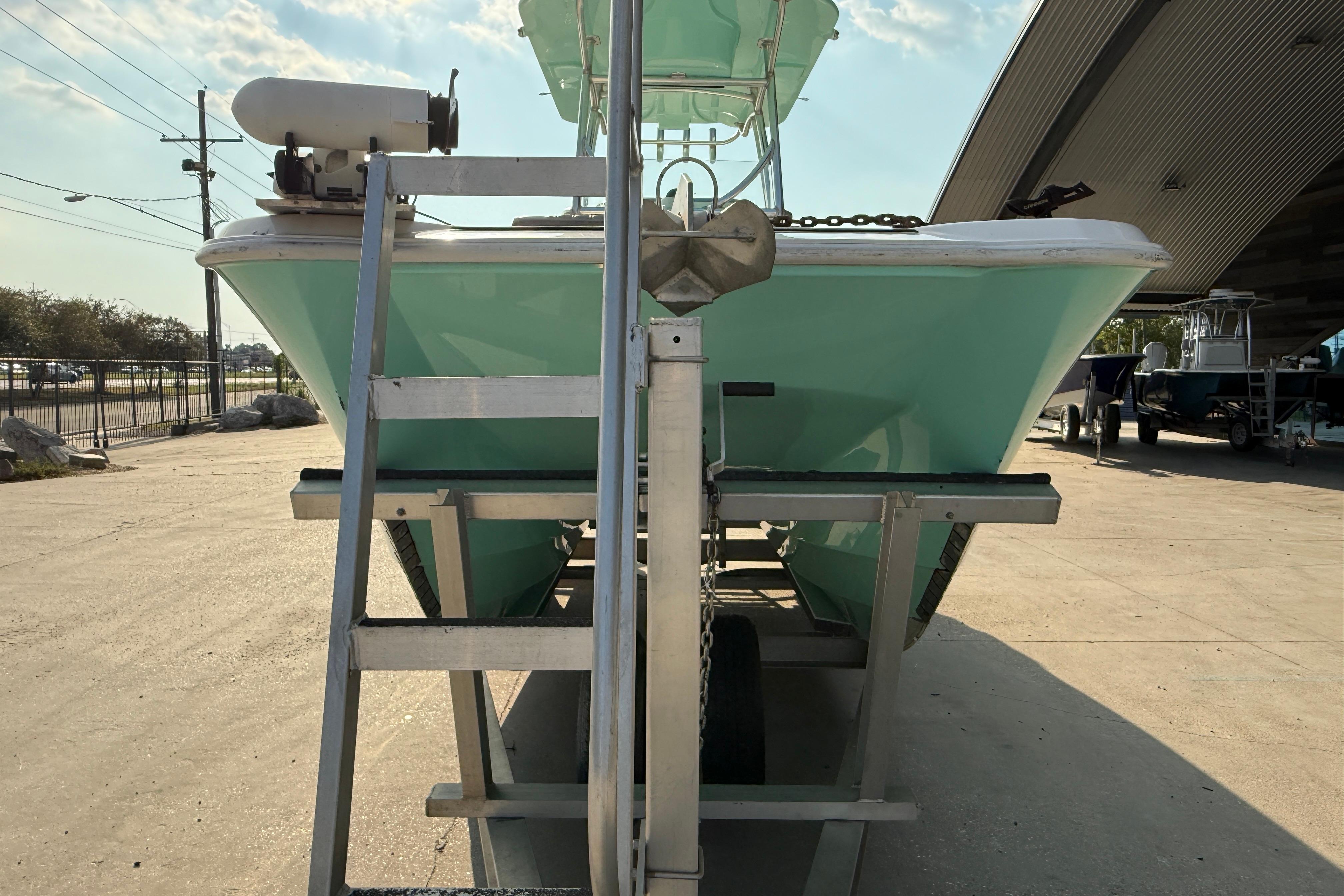 2020 Twin Vee 240 GFX CC boat on trailer, viewed from front, outdoors.