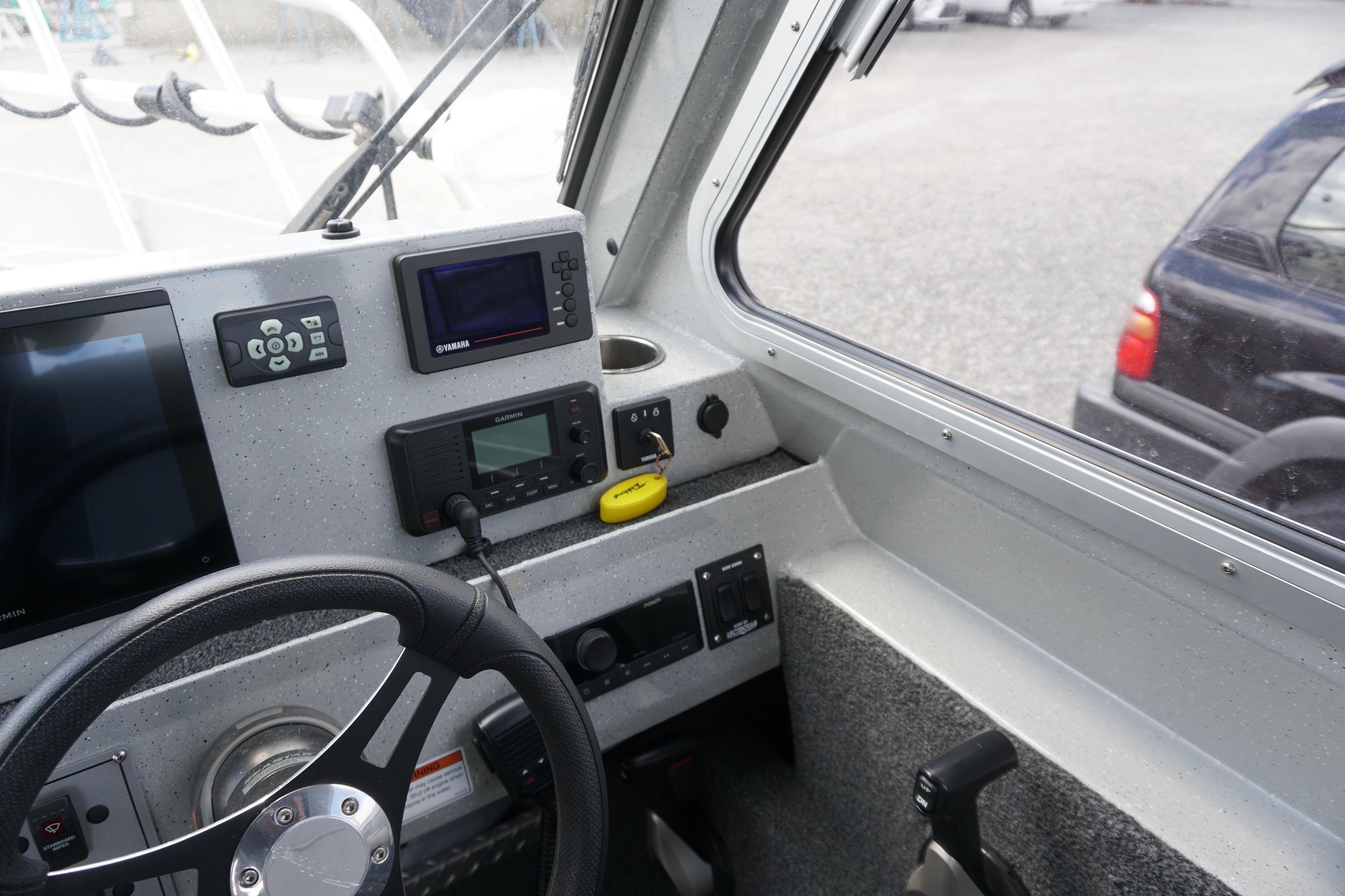 Interior view of 2023 Weldcraft Ocean King 220 boat cockpit with navigation equipment.