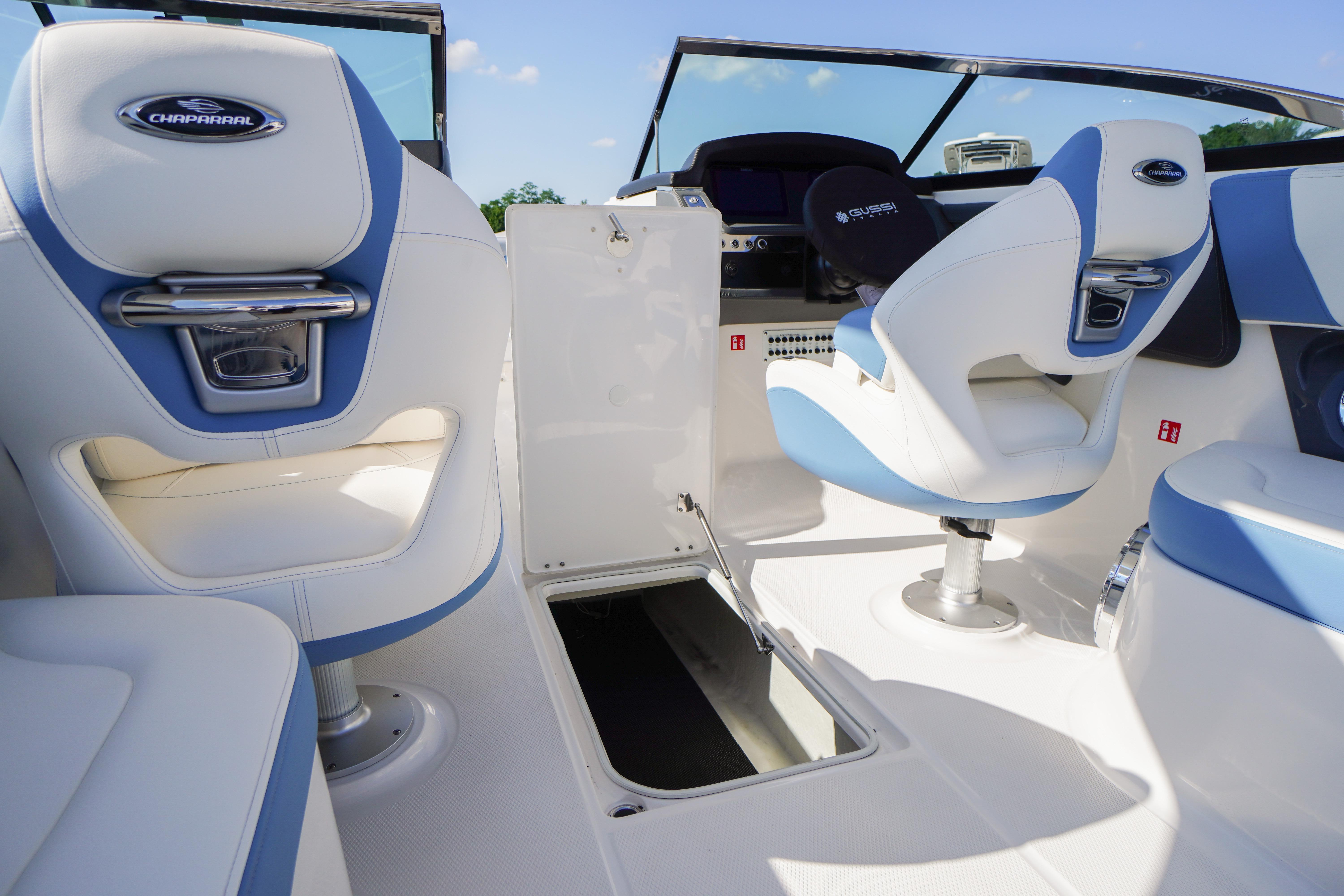 Interior of 2026 Chaparral 270 OSX boat with white and blue seating.