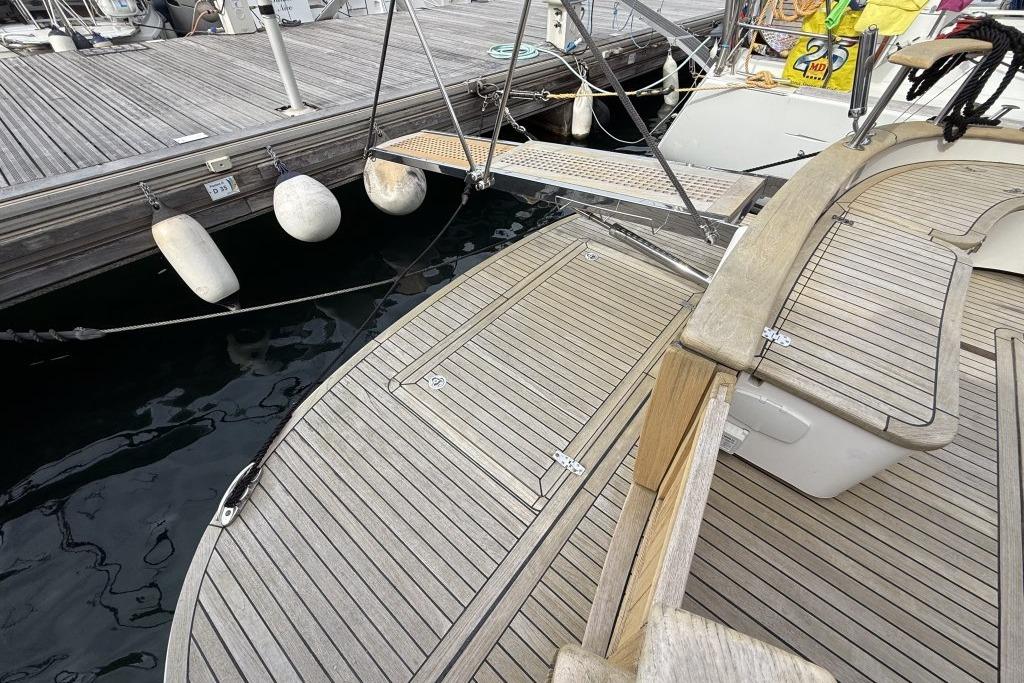 Teak deck of 2012 Sasga Yachts Menorquin 42 moored at a dock.