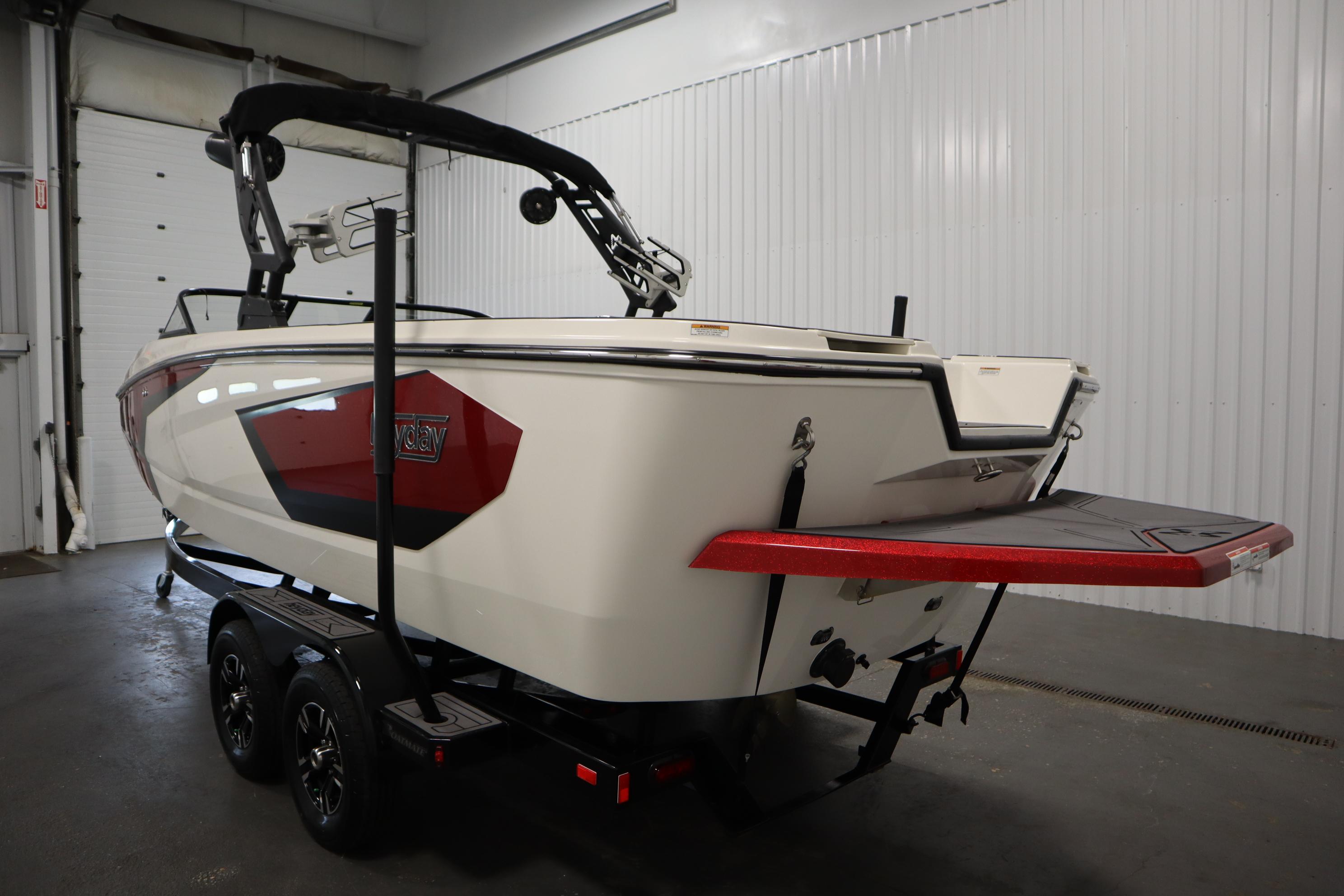 2023 Heyday WT Surf boat in a garage, showcasing sleek design and trailer.