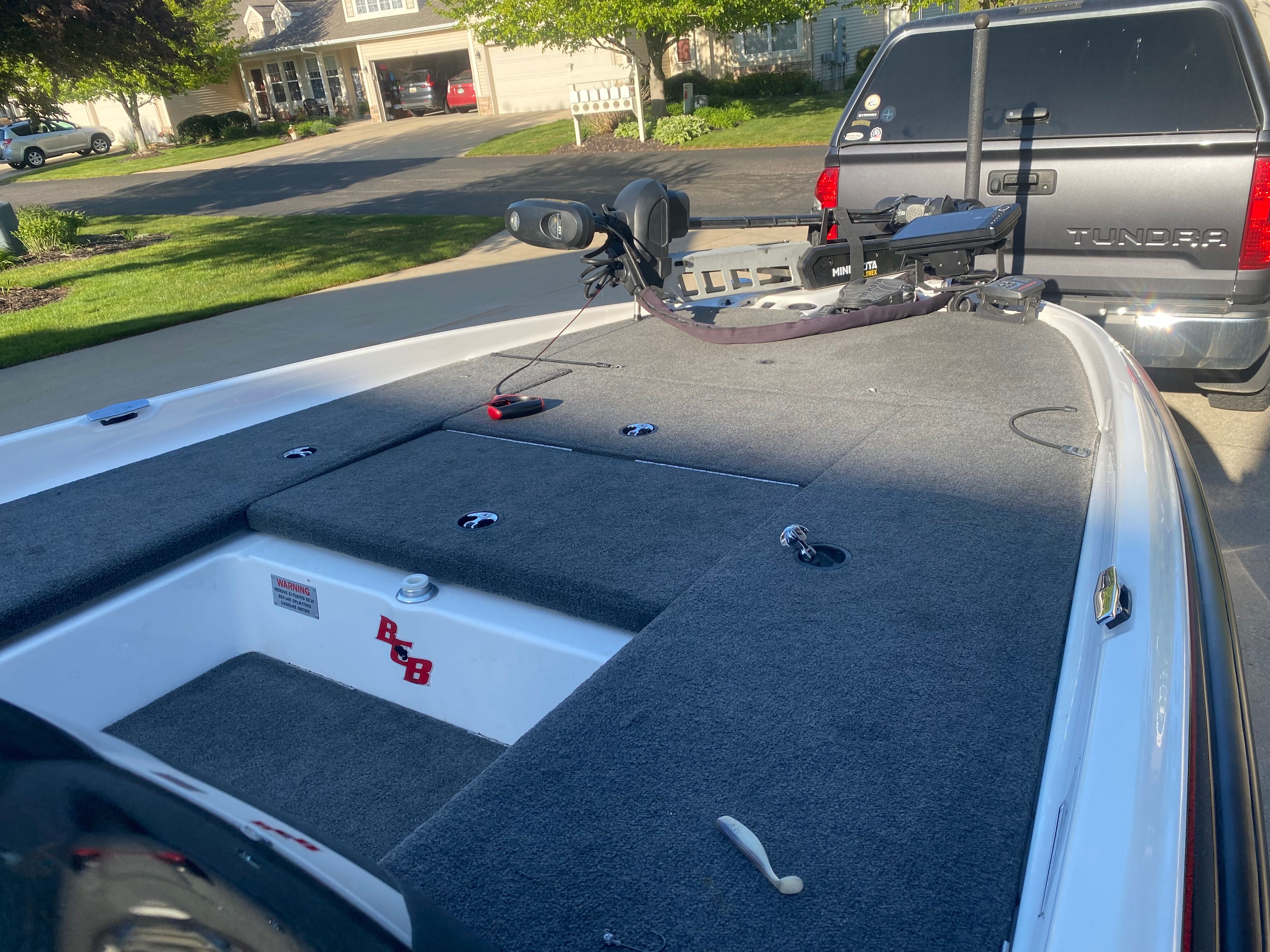 The image shows the deck of a 2014 Bass Cat Pantera II boat with gray carpeting.