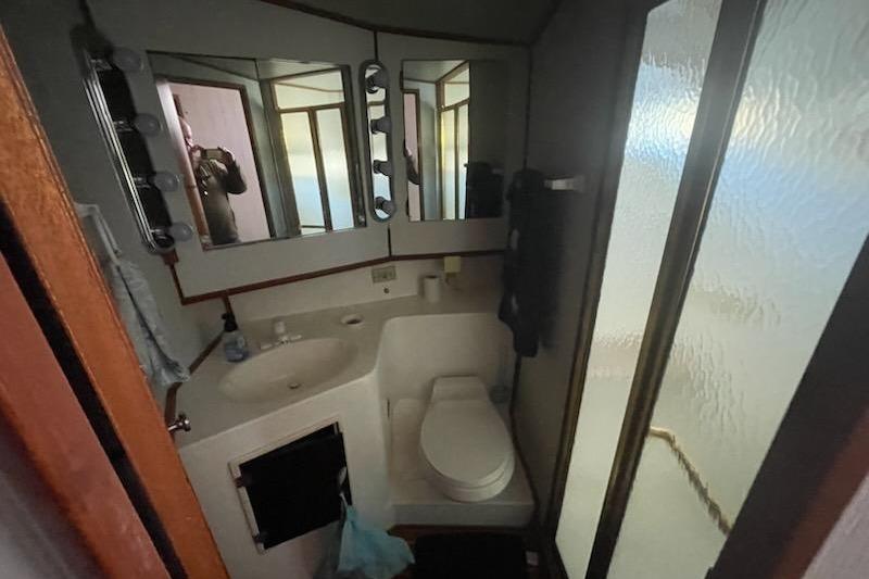 Bathroom interior of 1987 Topaz 44 Flybridge yacht with mirrors and shower.
