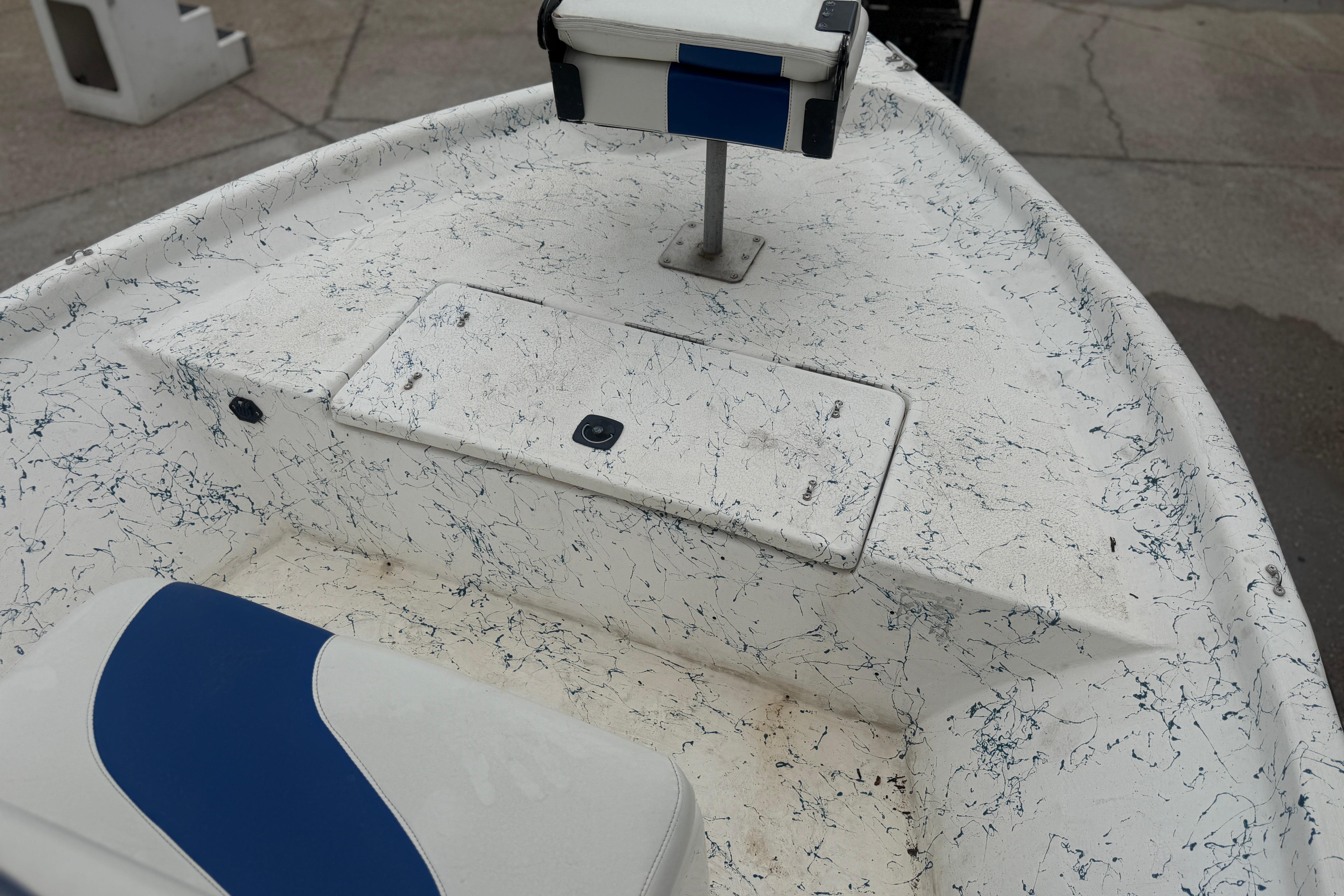 2004 Blue Wave 160 V-Bay boat interior with white and blue seating.