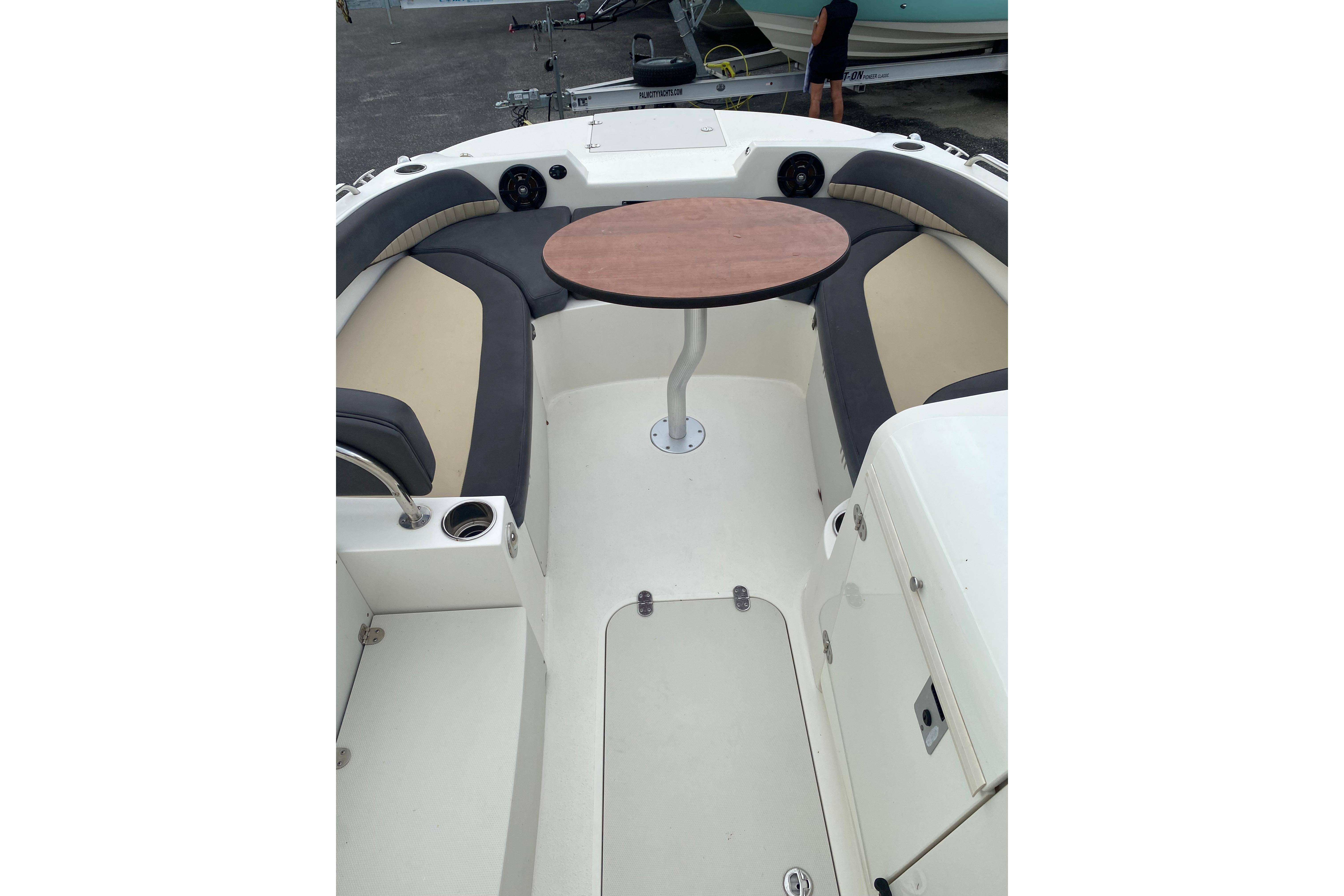 2018 Stingray 212 SC boat interior with seating and a central table.