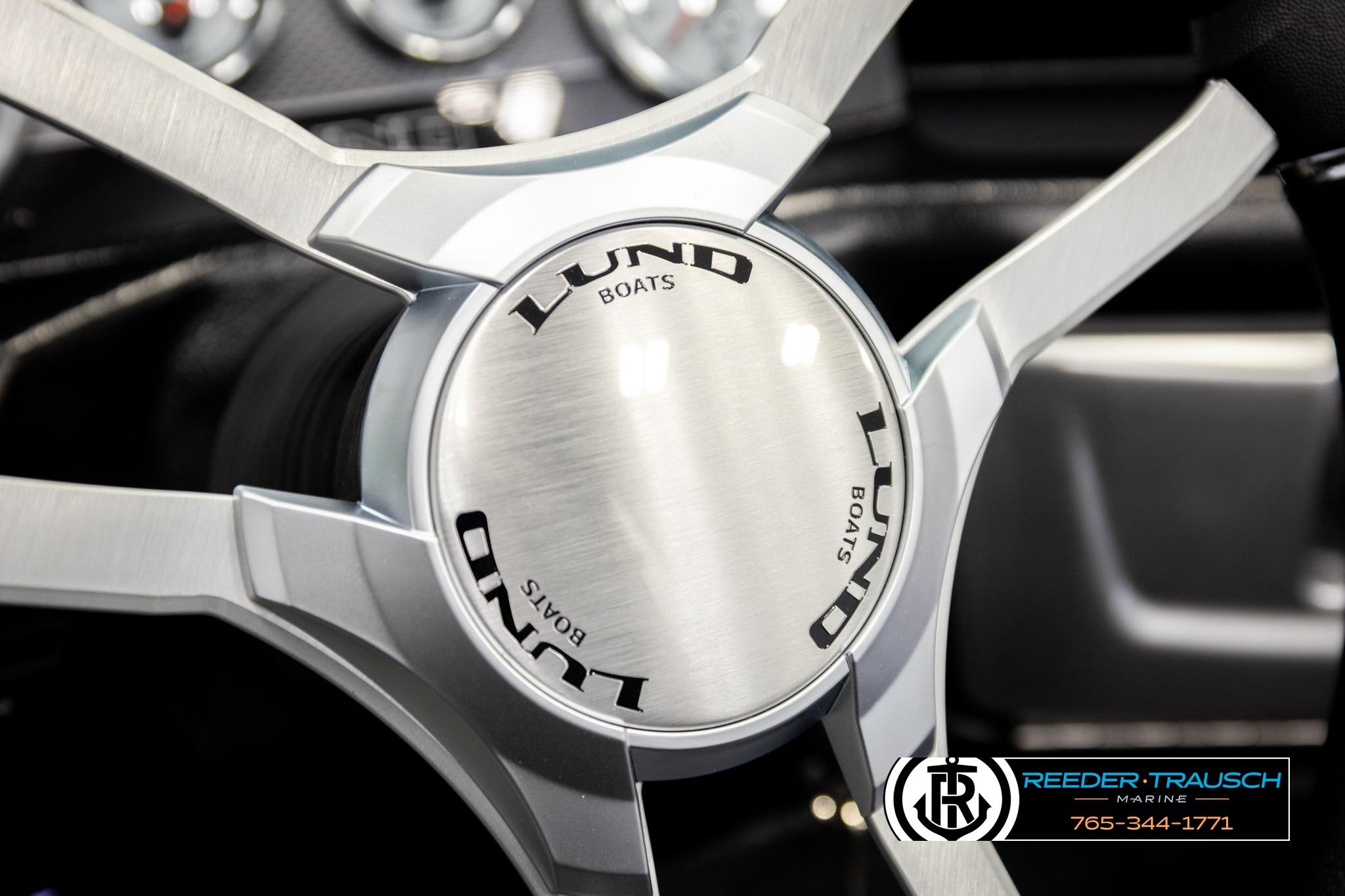 Steering wheel of 2026 Lund 1975 Pro-V Sport boat, featuring sleek metallic design.