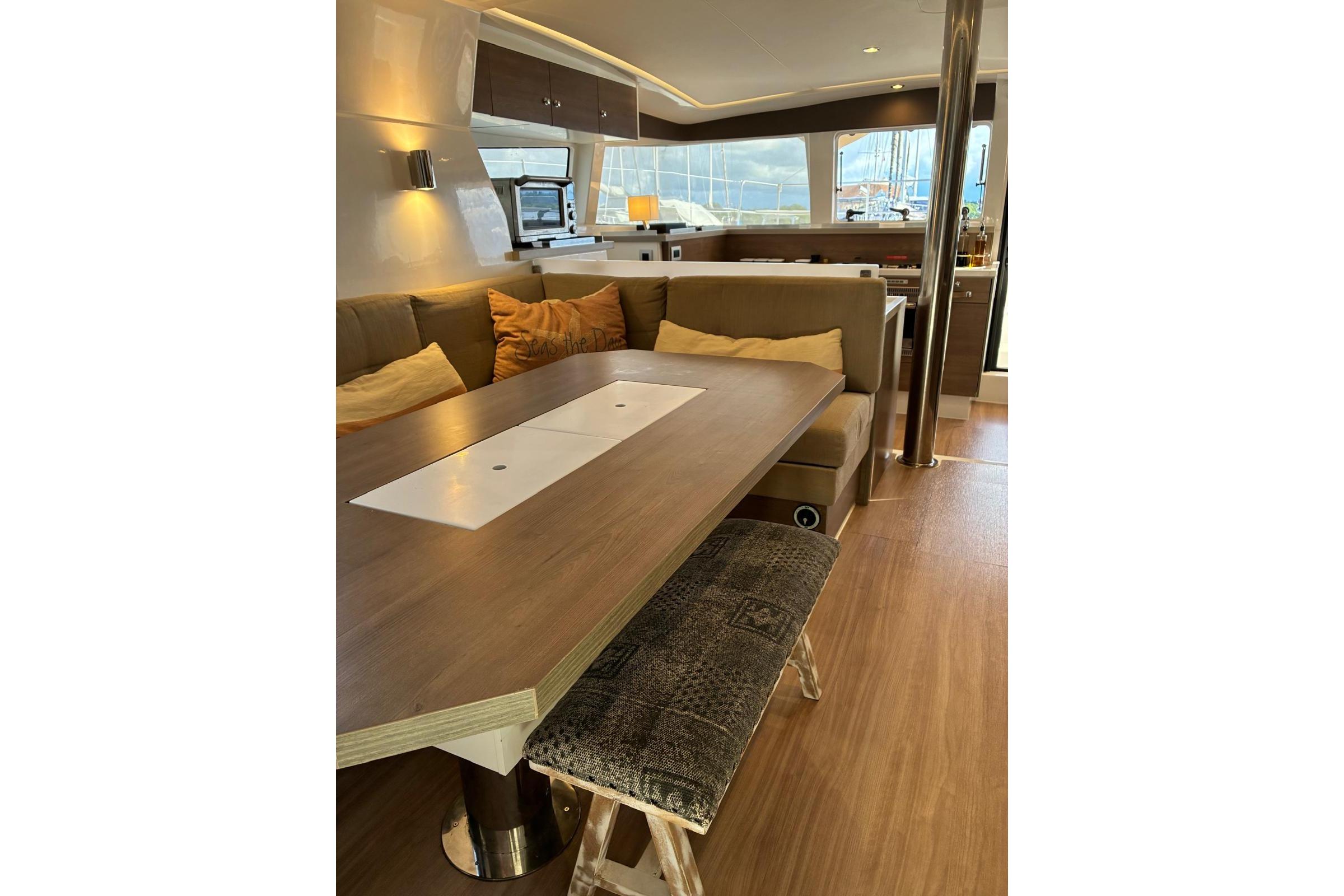 Luxurious interior of 2023 Bali 4.2 yacht with modern dining area and cozy seating.