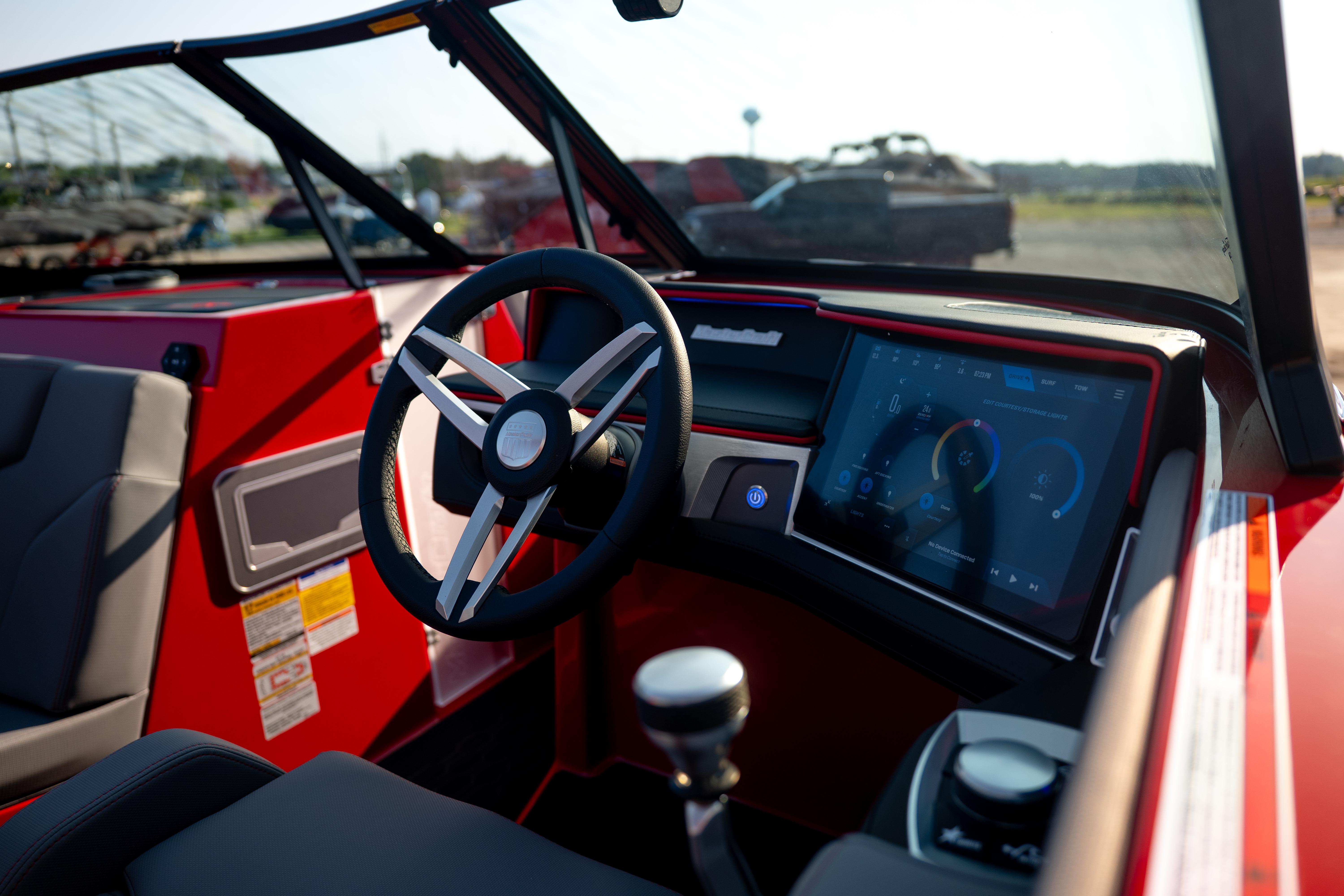 Interior of 2027 MasterCraft XT24 boat with modern dashboard and steering wheel.