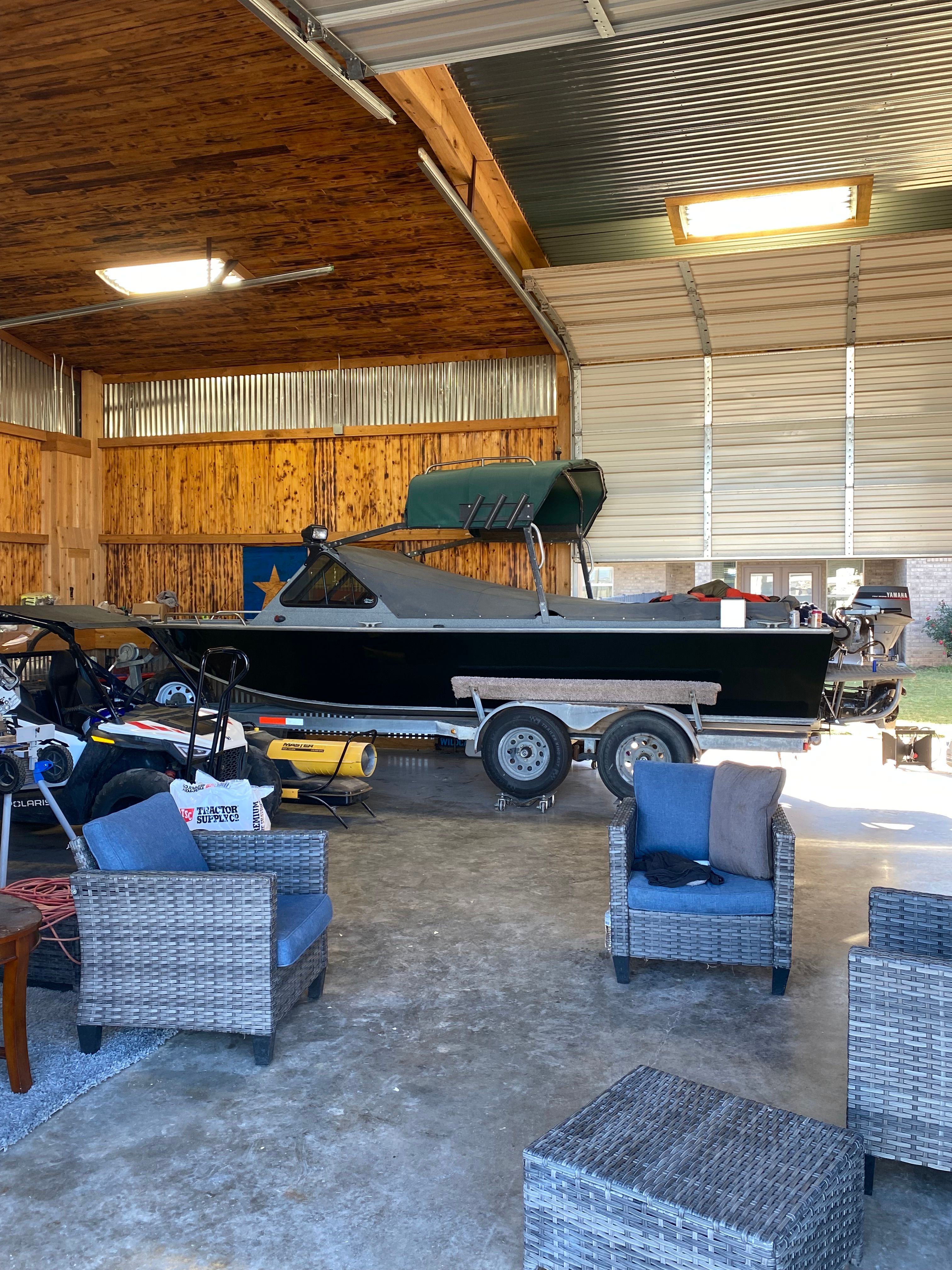 1993 Jetcraft Fastwater boat in a garage with furniture.