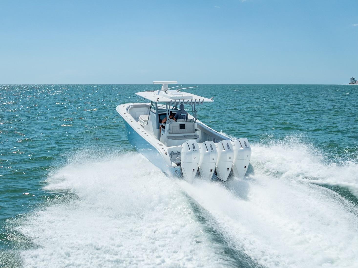 2024 Yellowfin 39 boat cruising on open water with four powerful engines.