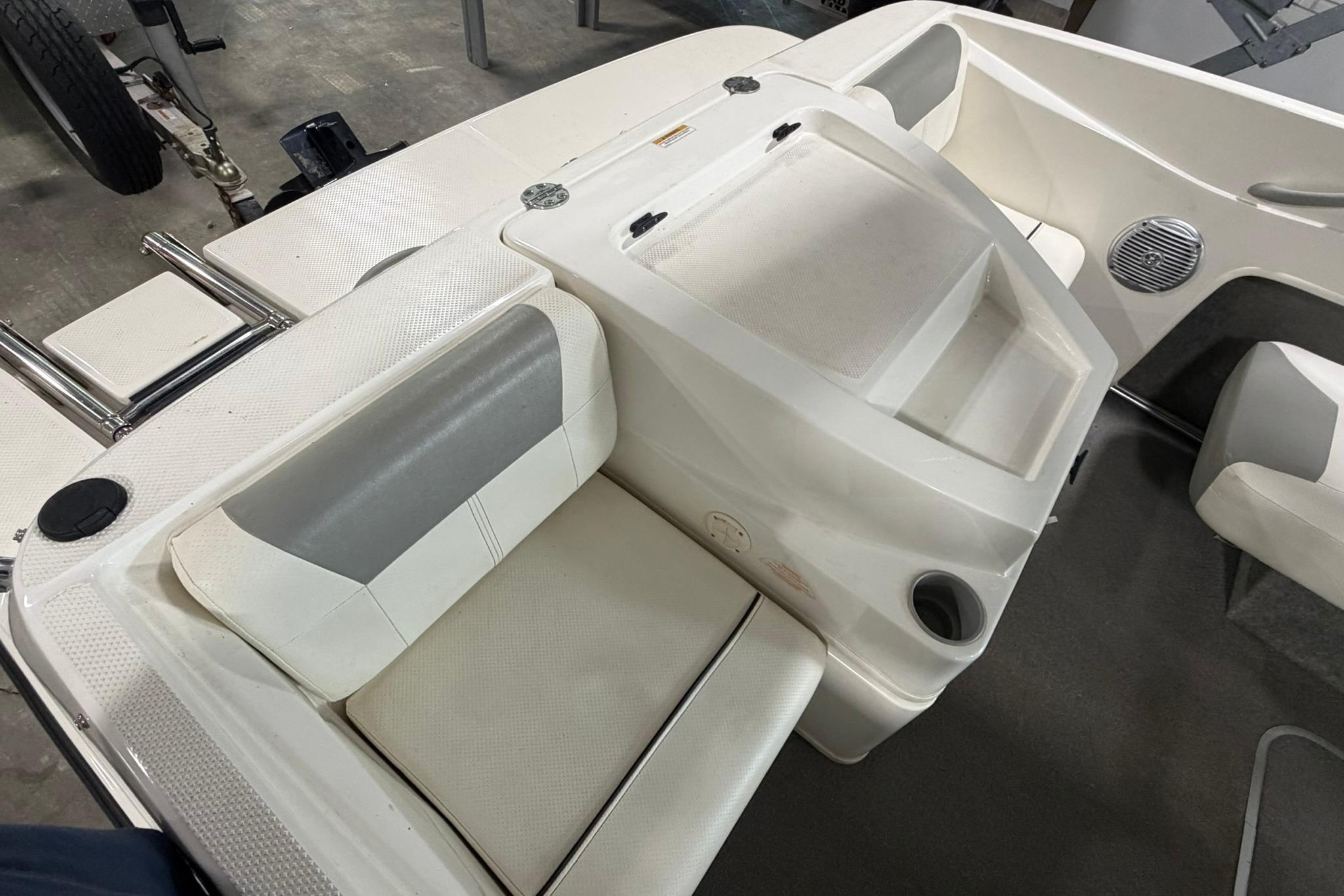 2012 Bayliner 175 Bowrider interior with white seating and storage compartments.