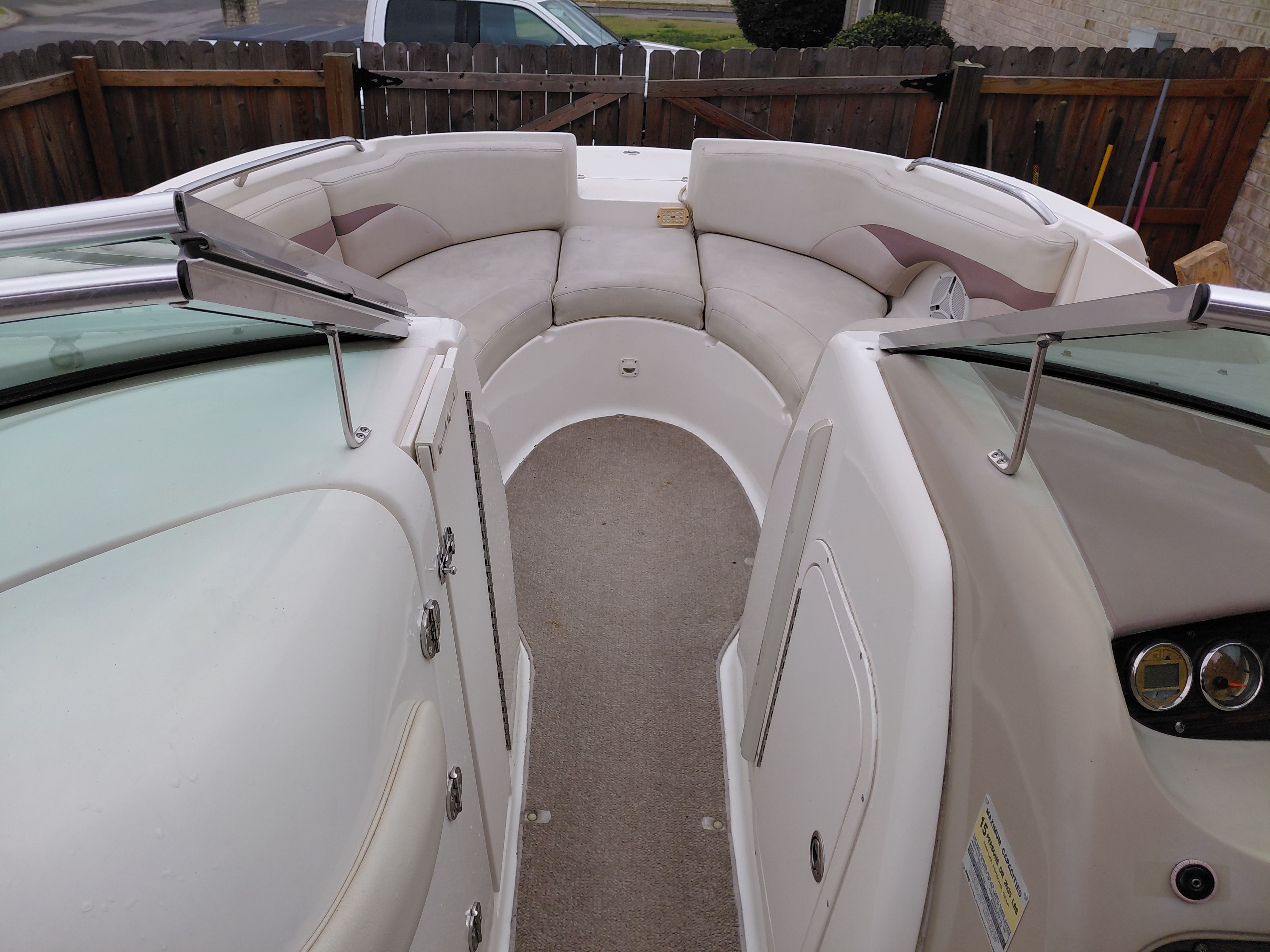 Interior of a 2005 Chaparral Sunestra 254 boat with seating area.