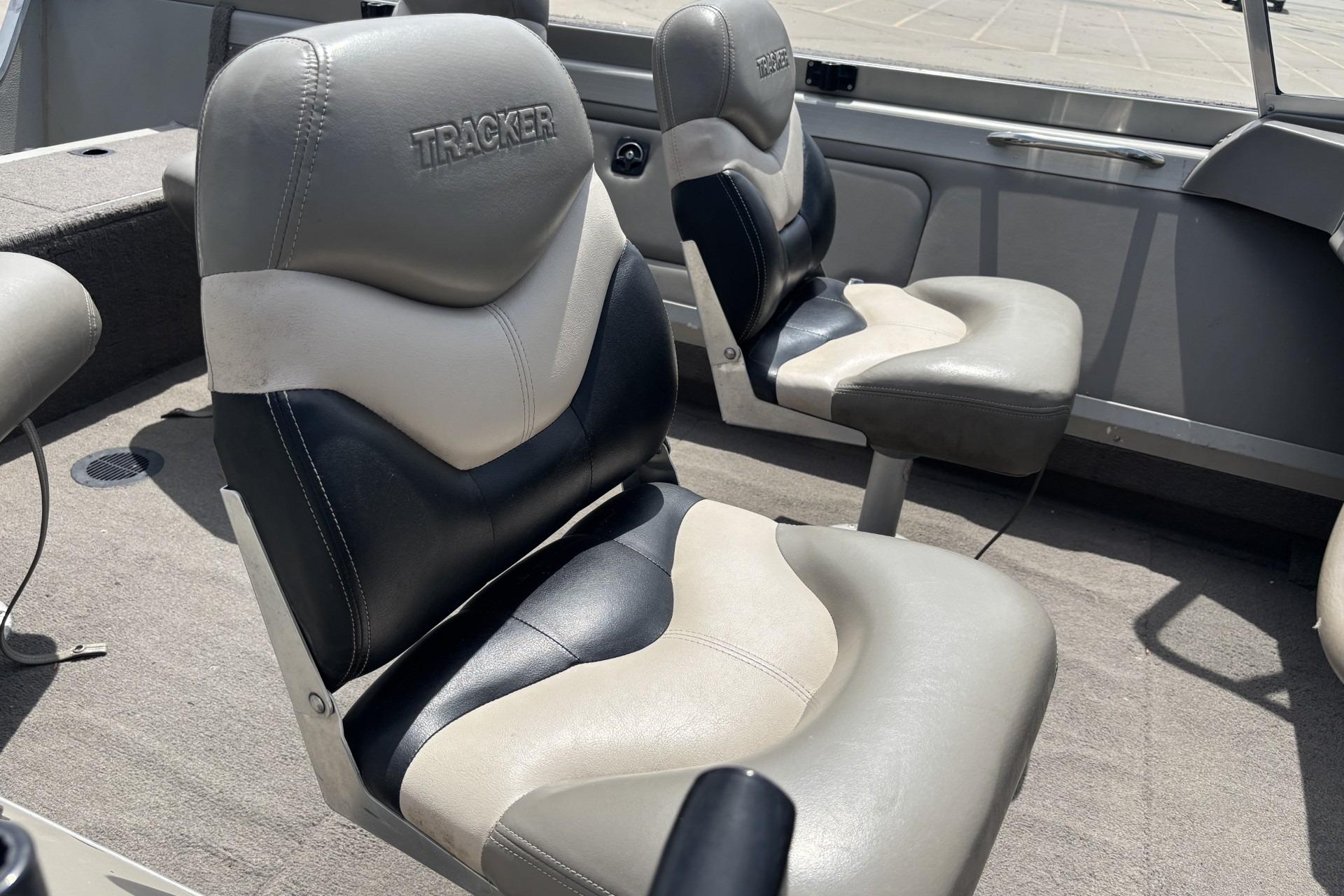 1999 Tracker Targa 18 boat interior with cushioned seats, gray and black upholstery.