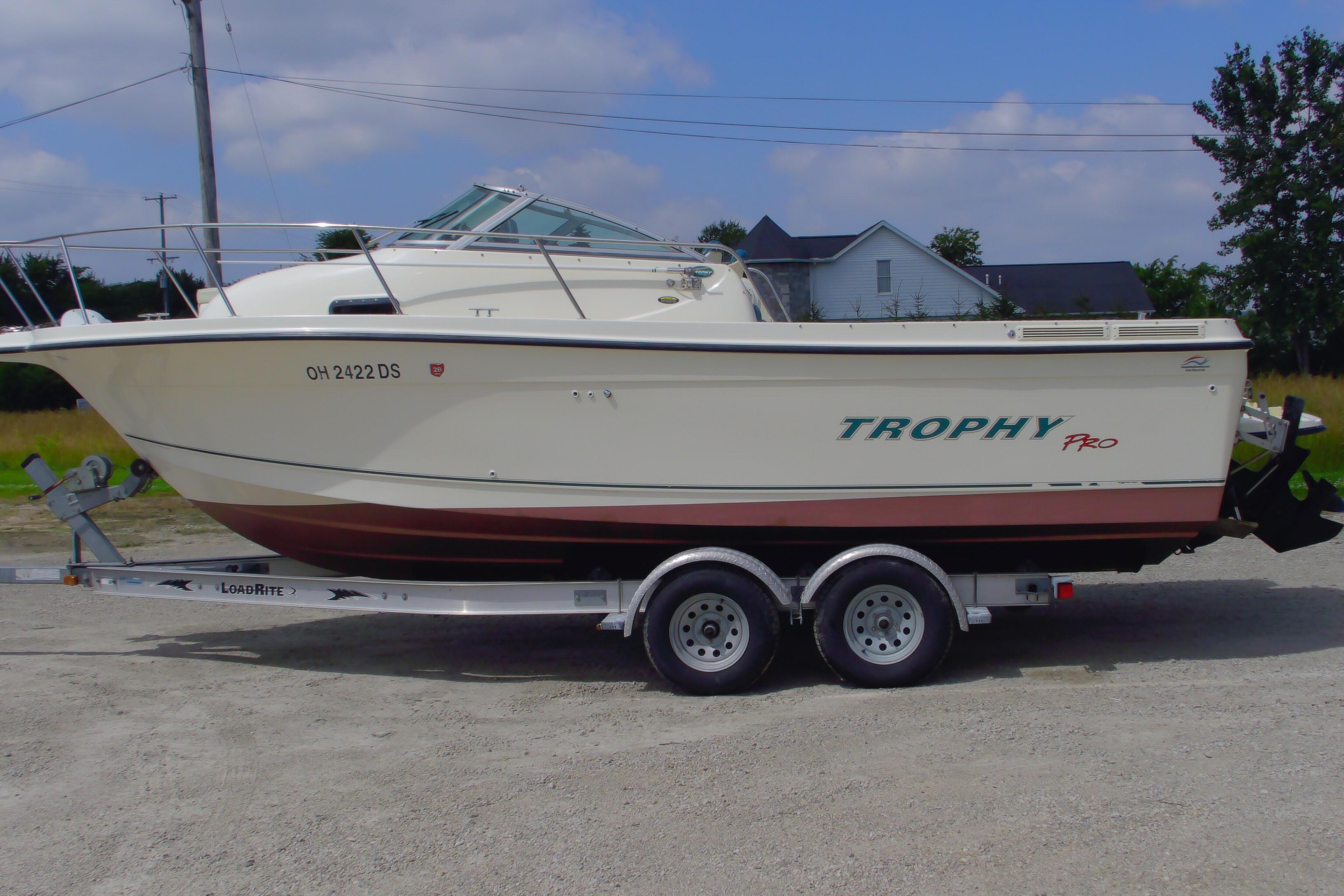 2004 Trophy 2352 Walkaround boat on trailer, side view, outdoors.
