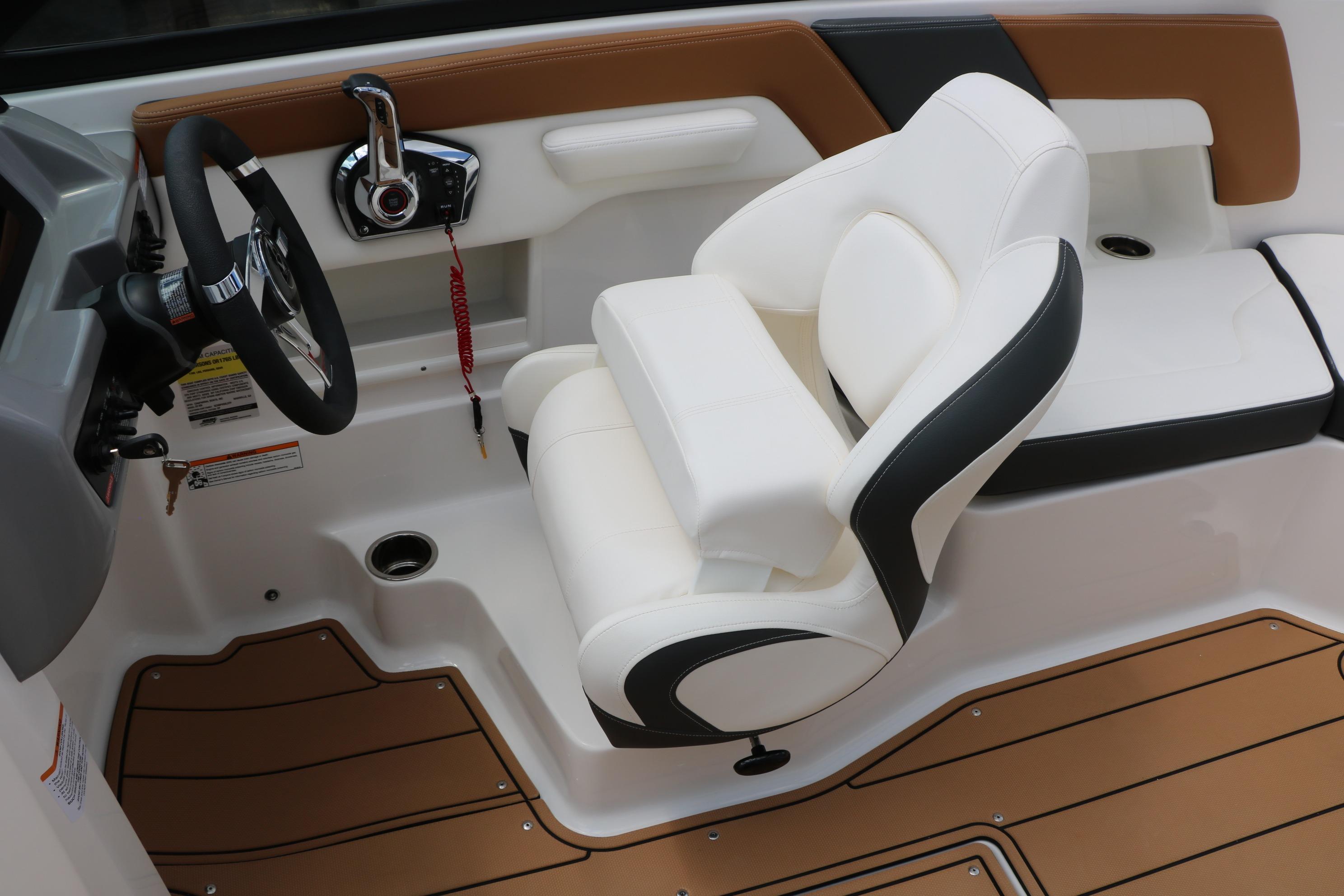 2025 Chaparral 23 SSi boat interior with white captain's seat and modern steering controls.