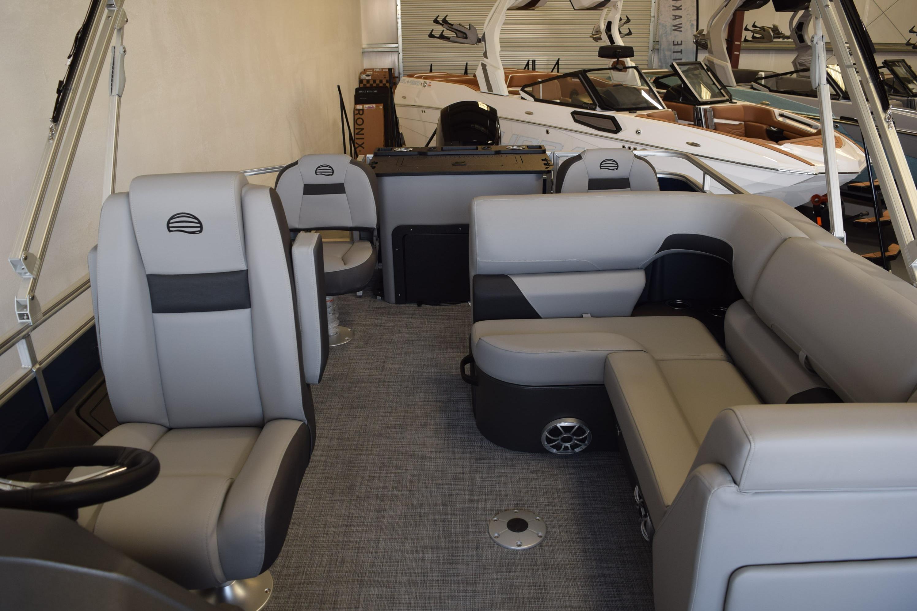 2026 Sun Tracker SportFish 22 DLX pontoon boat interior with gray seating and modern design.