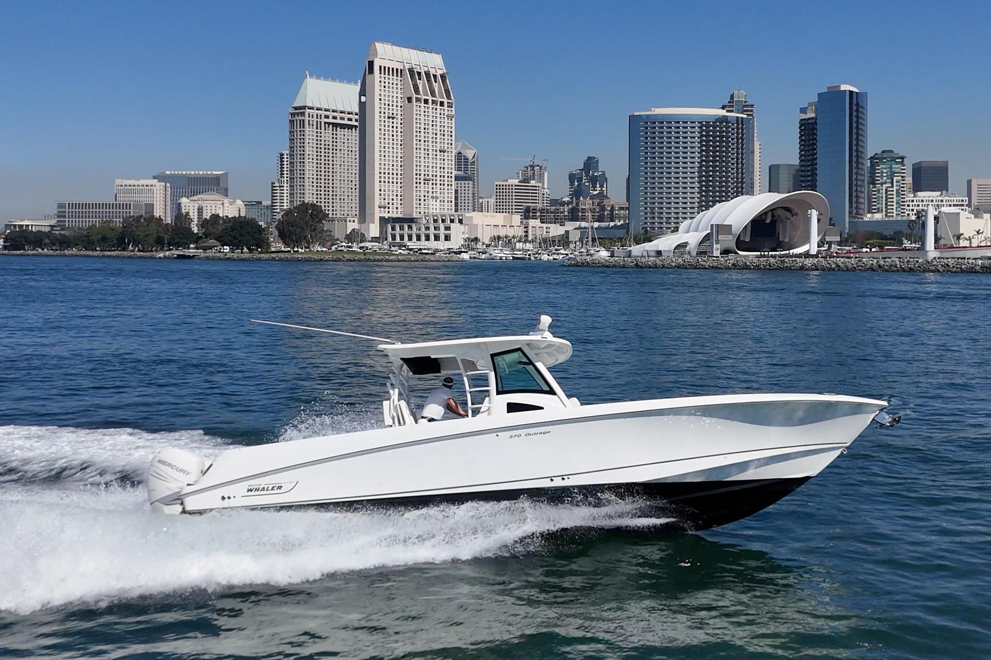 Boston Whaler 370 Outrage 2015 cruising in urban waterfront setting.