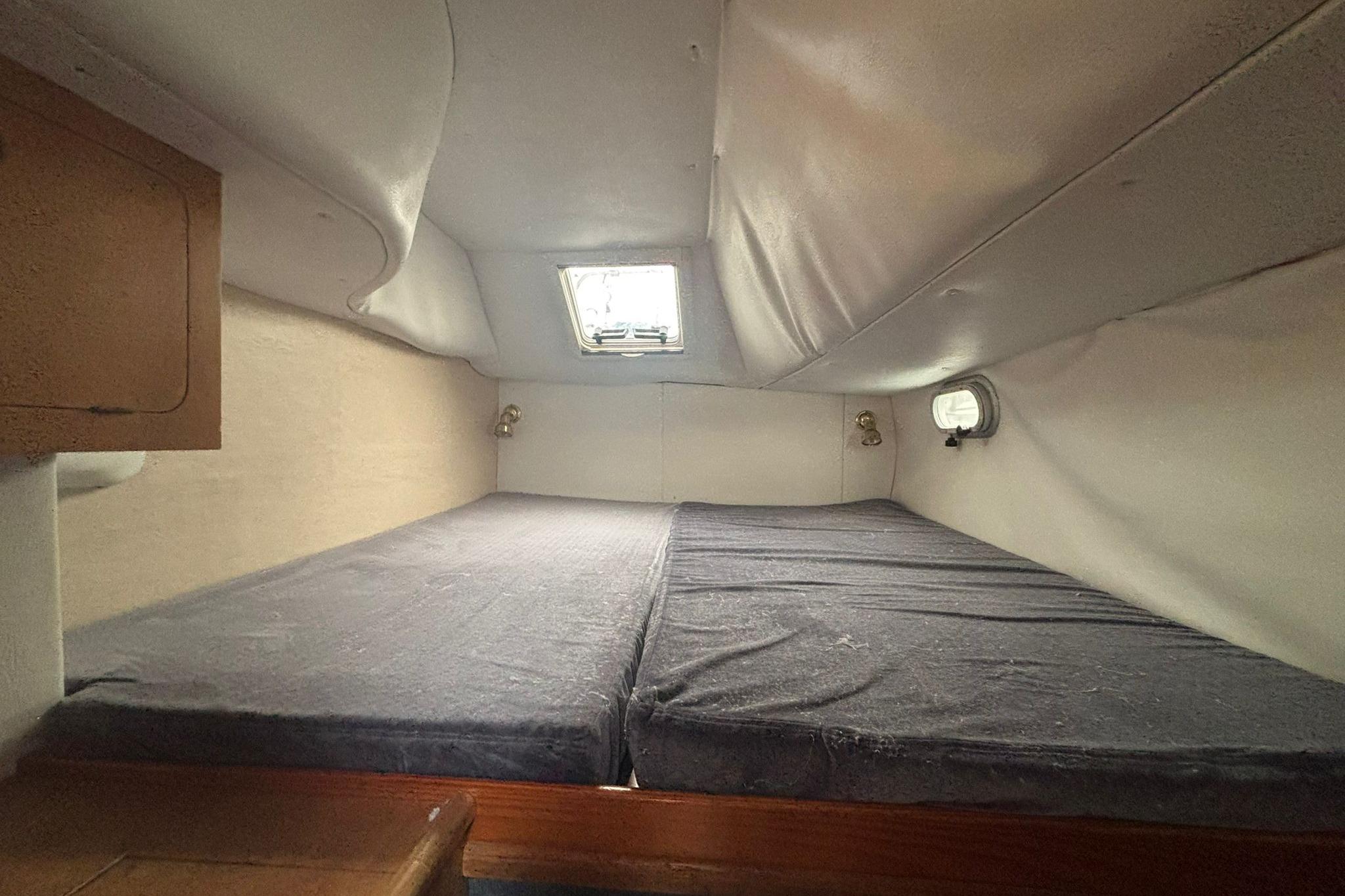 1998 Prout 38 cabin interior with twin beds and porthole window.