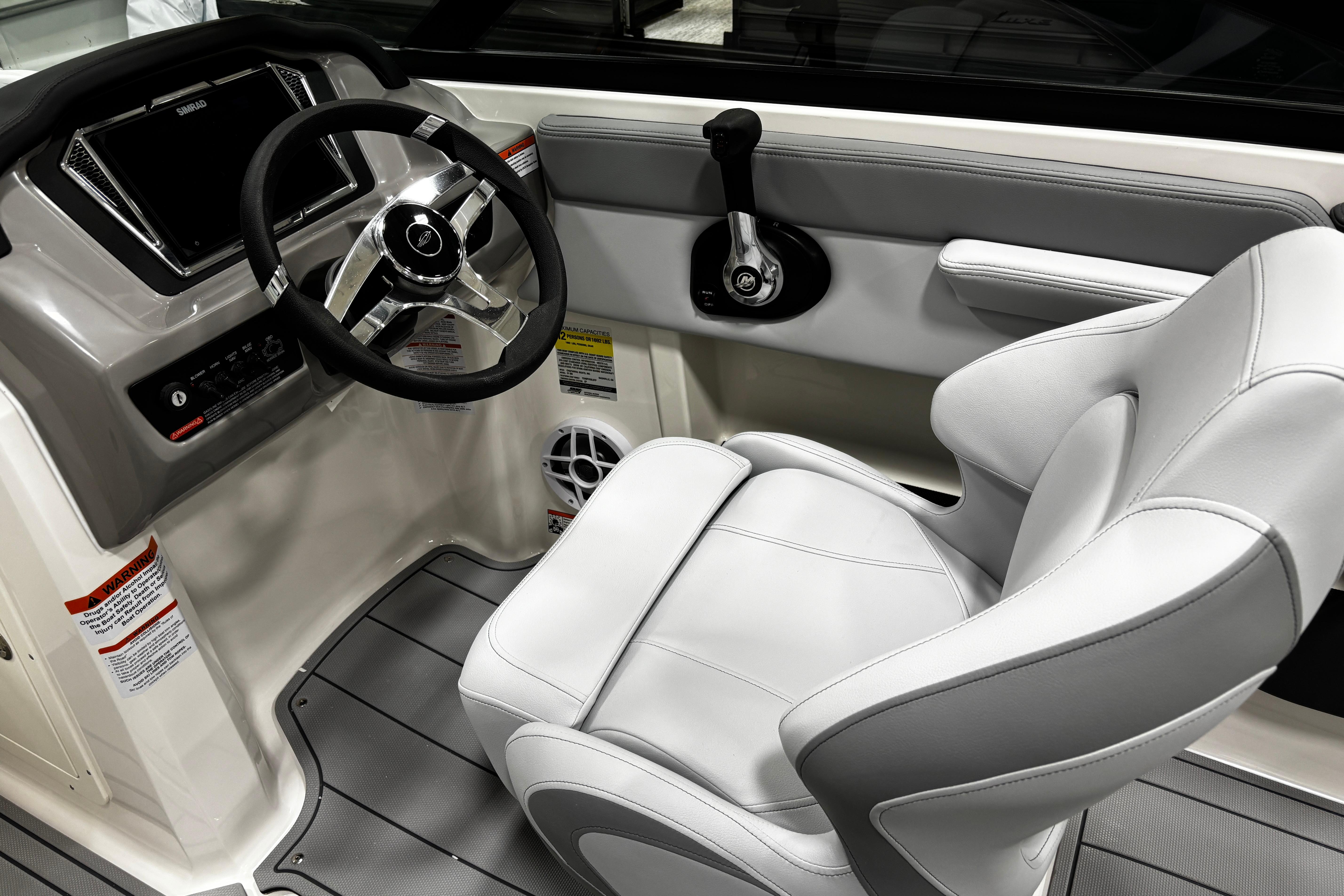 2026 Chaparral 21 SSi boat interior with steering wheel and captain's seat.