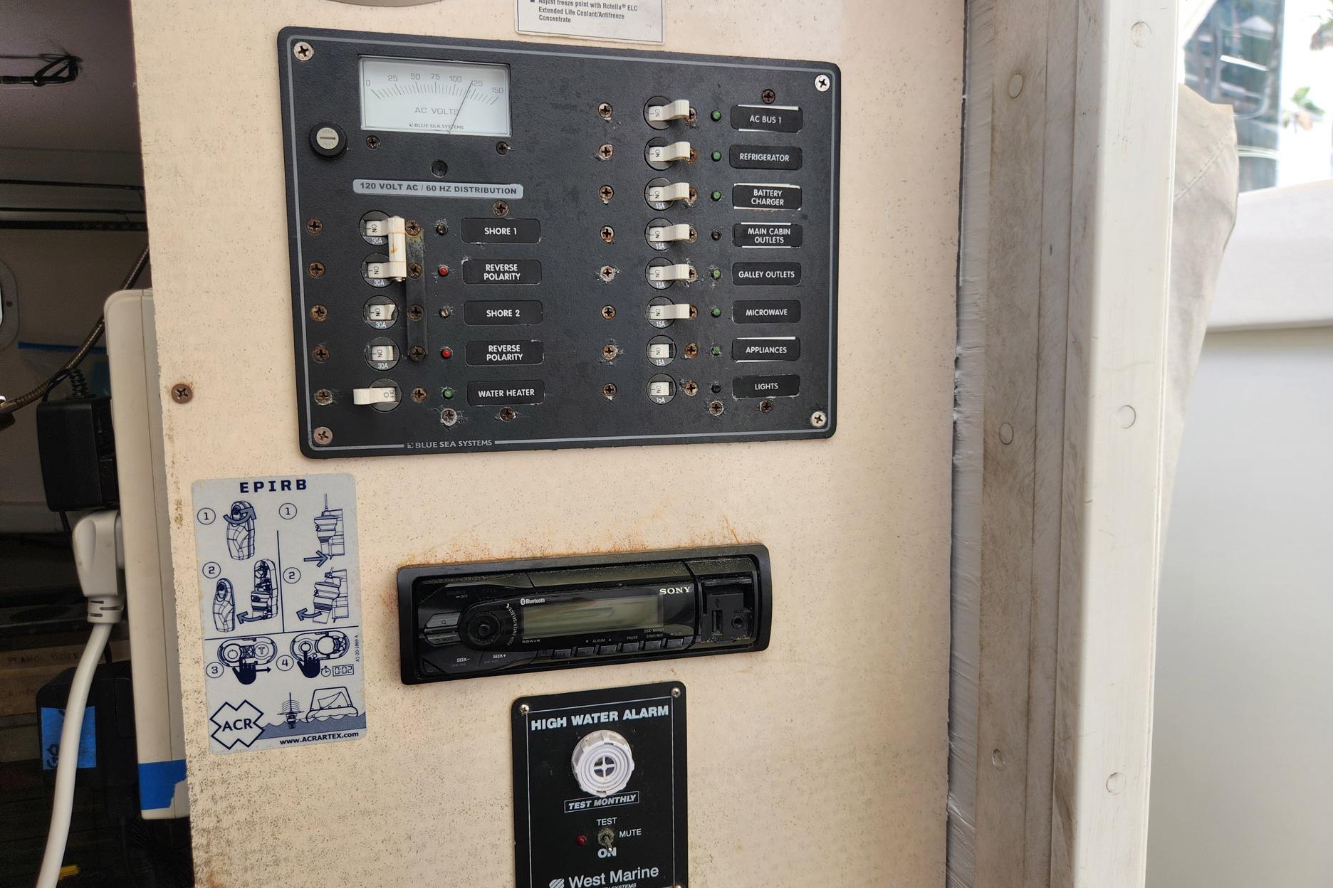 Electrical panel on a 1987 Young Brothers Custom Sport Fish boat with EPIRB instructions.