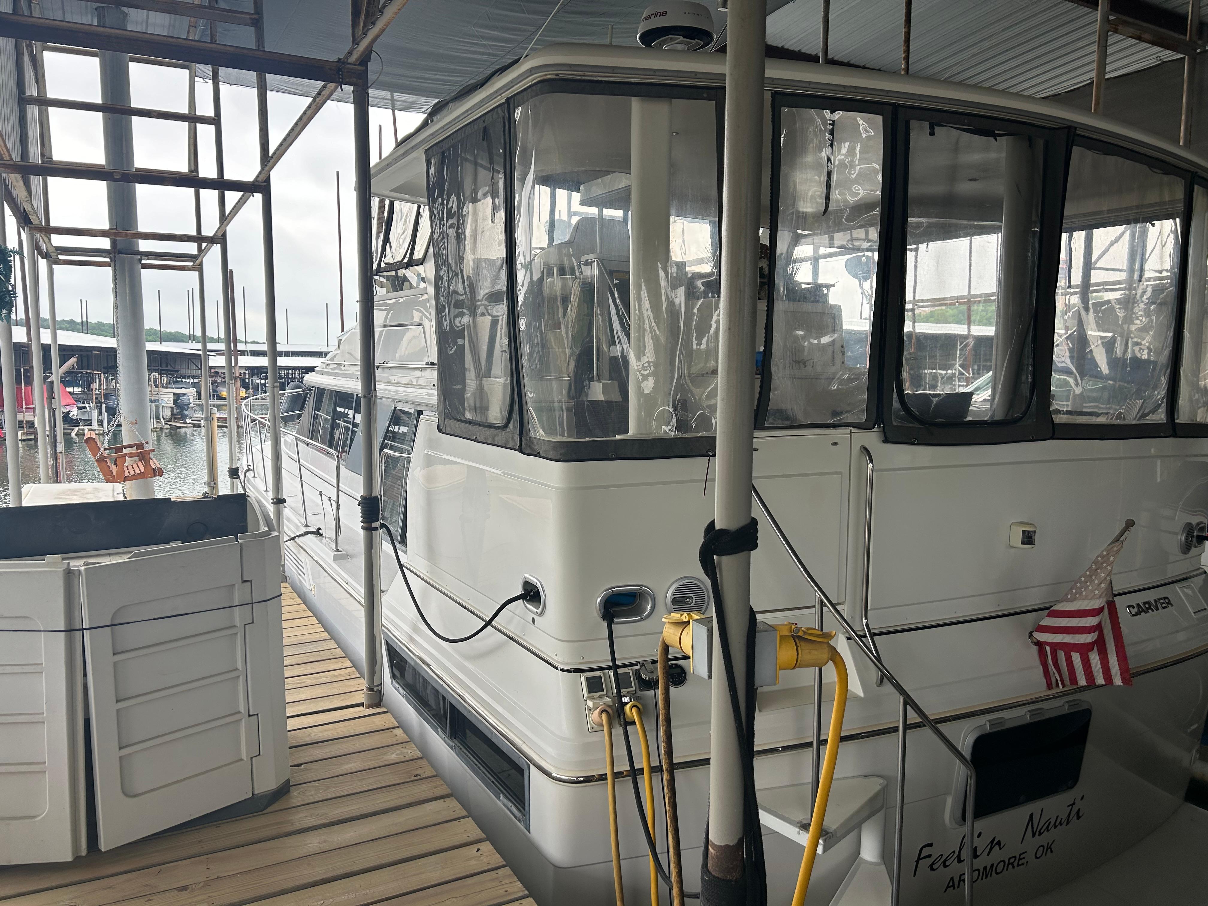 1996 Carver 440 Aft Cabin Motor Yacht docked at marina, side view.
