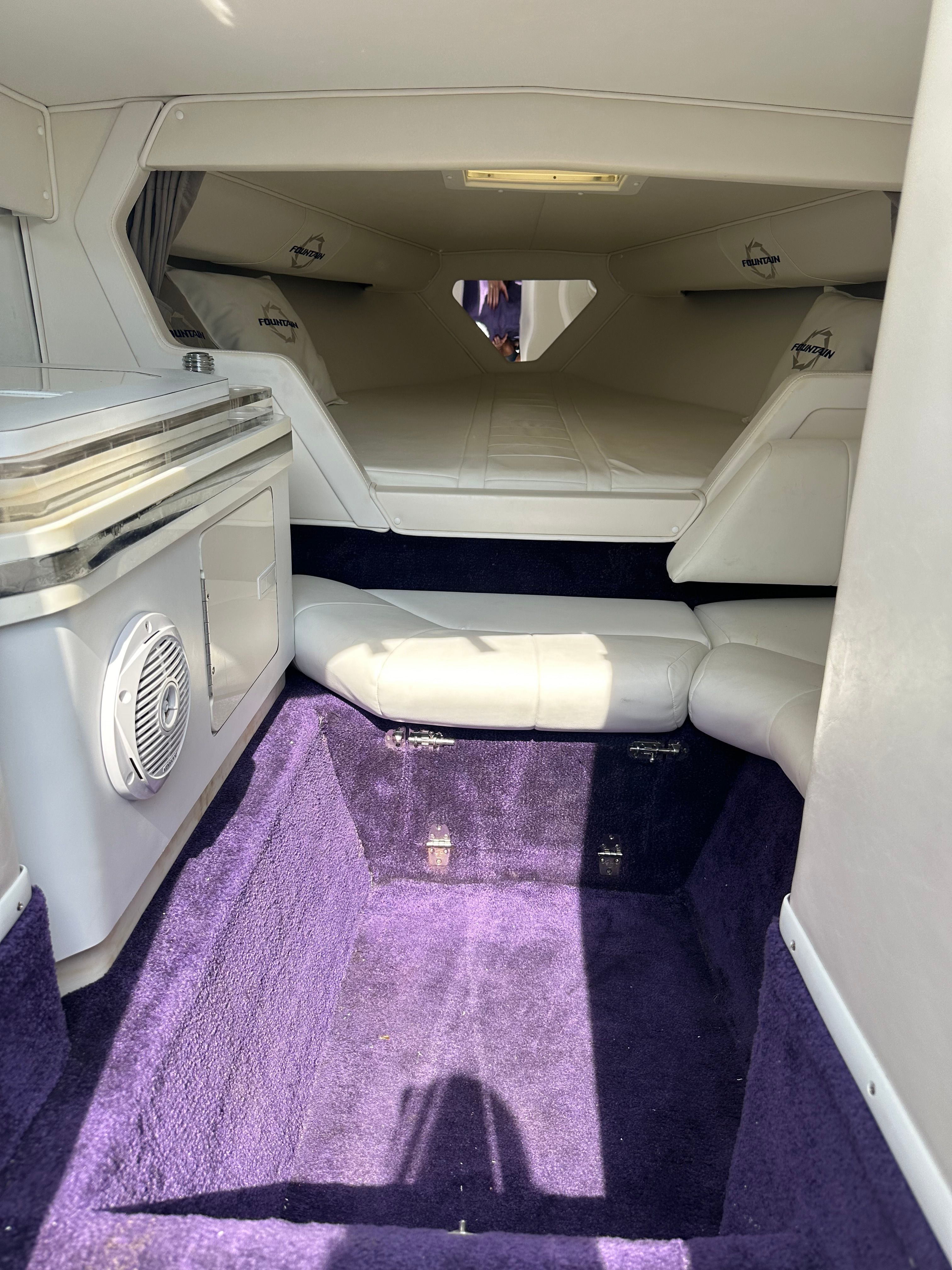 Interior of a 2006 Fountain 29 Fever with purple carpet and white upholstery.