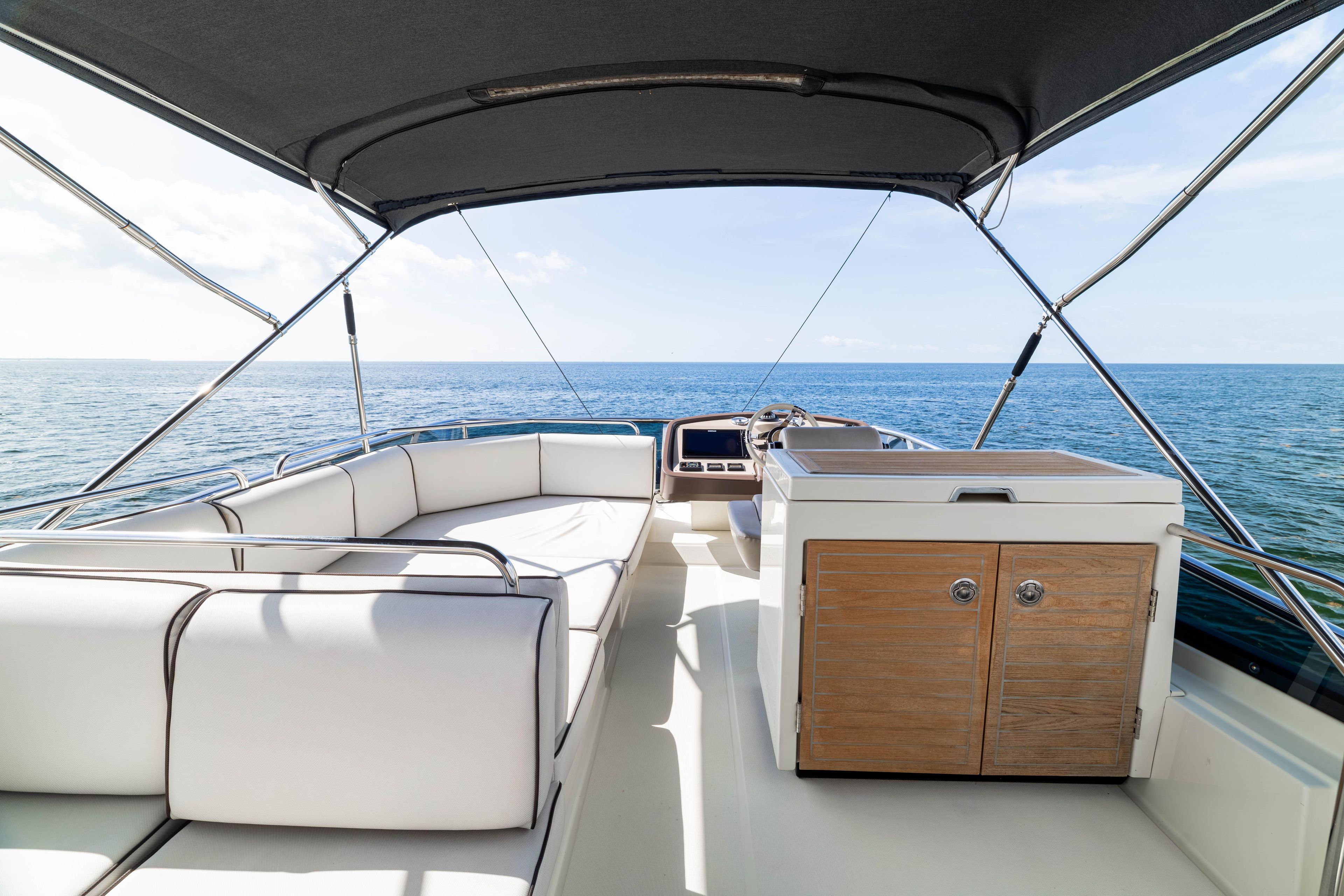 2017 Monte Carlo Yachts MC5 deck with seating, ocean view, and helm station.
