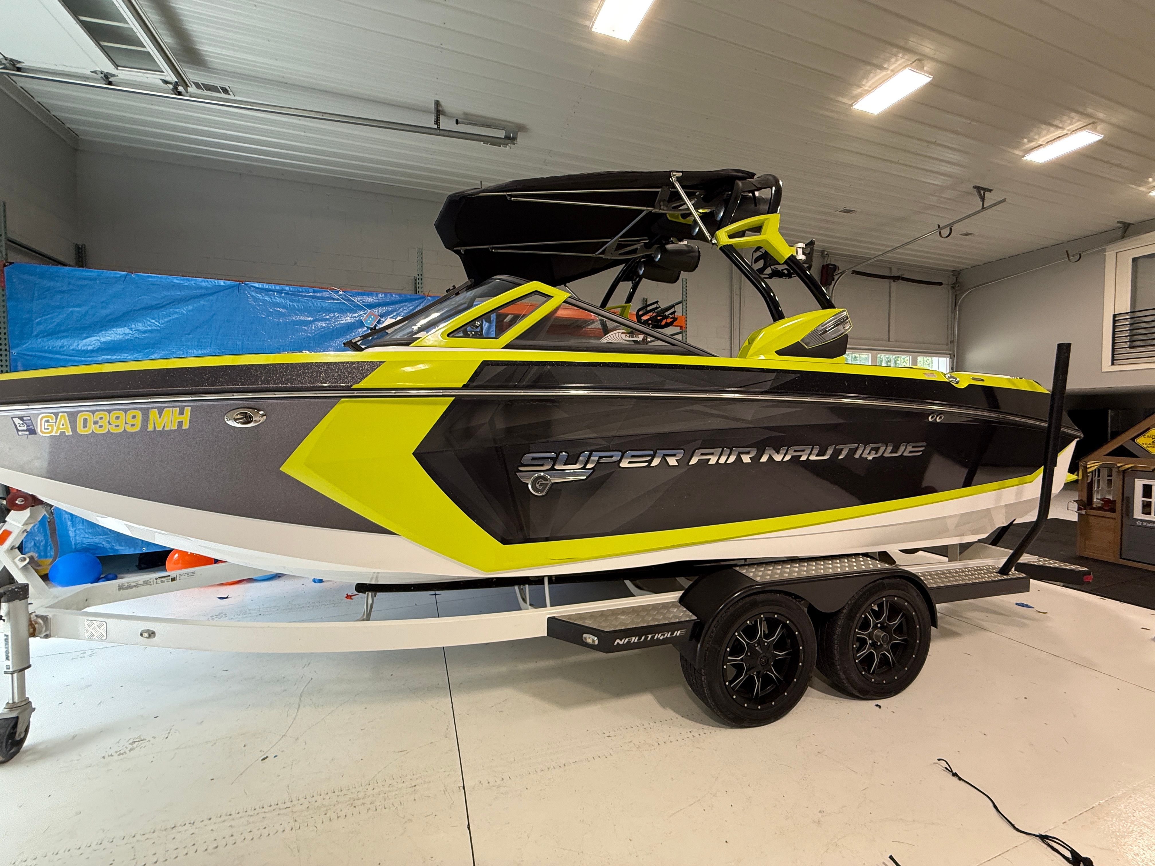 A 2016 Super Air Nautique G23 boat on a trailer in a garage.